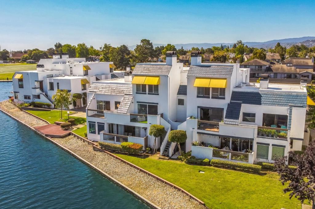 Live the waterfront lifestyle in Foster Citys prized Lido Isle! This rare 2-bed, 2-bath condo (approx. 1,780 sq. ft.) delivers bright, airy spaces and stunning lagoon views from both sides. An open great room features a fireplace and dining area that flows to a private balcony for morning coffee over the water. A sun-splashed family room with greenhouse windows frames the dock and lagoon. The updated kitchen showcases quartz counters, electric oven/range, dishwasher, refrigerator, pantry/utility room, and hardwood floors. Thoughtful upgrades include updated baths, plantation shutters, recessed lighting, crown molding, and skylight that draws in natural light. Upstairs, the primary suite with fireplace captures sweeping water vistas; a generous guest suite sits nearby. Convenient upper-level laundry with washer/dryer and 220V hookup. Resort-style amenities: lagoon-side pool, spa, and clubhouse, boat dock, and storage for kayaks, paddleboards, windsurfers, and small sailboats. Bay Area location near top San MateoFoster City schools, parks, shopping, and Hwy 92/101. Your waterfront condo awaits! Enjoy high ceilings and natural light with water views at every turn. Ample storage including pantry/utility room and generous closets. Move-in ready and impeccably maintained.