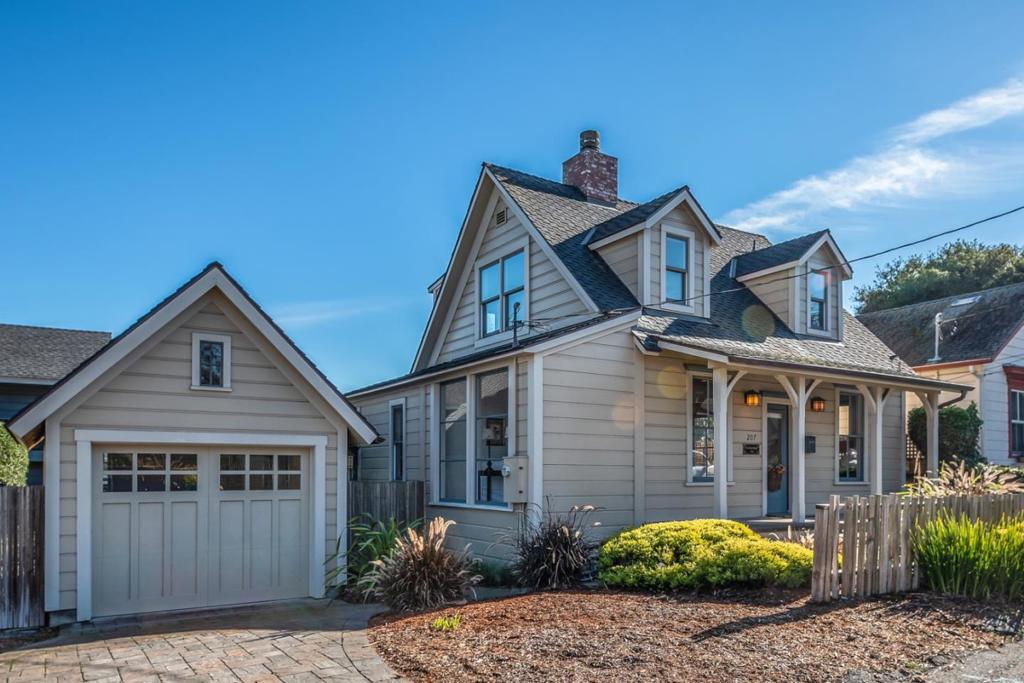 This beautifully rebuilt Pacific Grove cottage is in a great near-town location on a large lot. The home is bright and cheerful with lots of windows and high ceilings and consists of a spacious, light and airy living room with limestone fireplace and hardwood floors, dining room, generous functional kitchen with limestone countertops, a comfortable family room, and 1-car garage. The ground floor master suite opens to a private deck, and the 2 upstairs bedrooms offer peeks of the Bay views, all within an easy stroll to downtown.