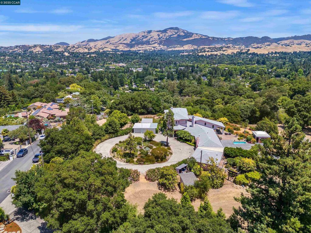 Extraordinary westside Danville gated custom estate property on the market for the first time in 3 generations offers a wealth of possibilities to create the ultimate dream estate, subdivision, or family compound. Add vineyard, orchard, resort-inspired outdr amenities. 3.66 acres at the base of the Las Trampas Ridgeline was part of original ranch land. Awe-inspiring unobstructed 180-degree views encompass Mt. Diablo and scenic hillsides. 5500+/- SF. Open concept design. Great room. Walls of windows. Soaring exposed beam & 18-ft plank ceilings. White oak & marble tile flrs. Wood-burning frpl. Wet bar. Galley-style kitchen w/granite counters, Miele dual ovens, cooktop, KitchenAid cooktop. Hand-carved Rosewood double dr entry. Seamless flow from just about every room to wrap-around loggia, pool, lush gardens, mature fruit, shade and oak trees. 5 en suite bdrms, 5 bths inclds private upper-level 1200+/-SF primary suite w/sitting room, view windows on 3 sides, dual walk-in closet rms & en suite w/dual vanities, tiled walls & flr, walk-in shwr. Gated circular driveway. 3-car detached garage. Deer fencing. Upgraded water heater. Upgraded furnace in primary suite. Laundry/mudrm w/frt access. Less than a mile from downtown, weekly farmers market, Iron Horse Trail, top-rated SRVUSD schls.