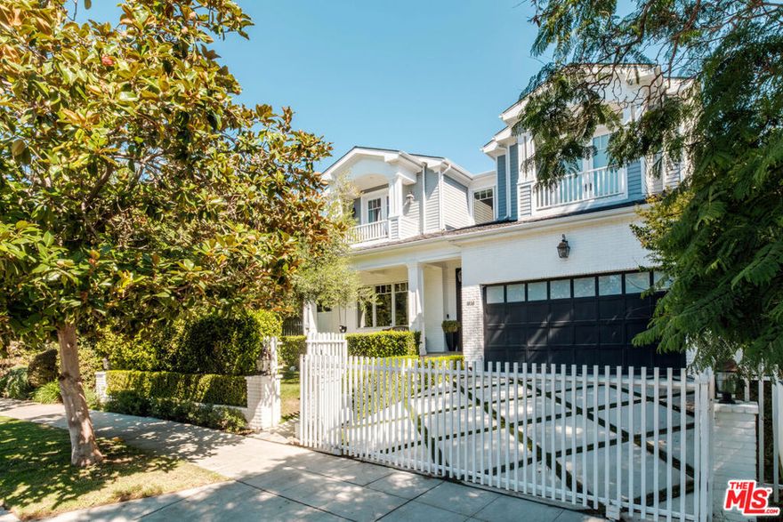 Set within one of Westwood's most coveted neighborhoods, this exquisite custom-built residence blends timeless traditional architecture with modern luxury. Spanning over 5,000 square feet, the home welcomes with warm wood floors, bespoke millwork, and coffered ceilings that exude sophistication and craftsmanship at every turn. The formal living and dining rooms provide convenient access to a wine cellar, creating an ideal space for entertaining. Just beyond, the sunlit family room opens through French doors to a covered stone patio with an exterior fireplace, for effortless indoor-outdoor living. At the heart of the home lies a gourmet chef's kitchen, adorned with striking stone countertops, a seated island, and premium appliances, including a Wolf gas range and double ovens. The space also boasts a full-sized refrigerator and freezer, abundant pantry storage, and a charming breakfast banquette overlooking the backyard. Ascend the curved stairway to the expansive primary suite. This private sanctuary impresses with vaulted ceilings, a balcony, and dual custom walk-in closets. The spa-inspired en suite bath is a serene retreat with dual vanities, dual separate water closets, a glass-enclosed shower, and a luxurious soaking tub. Find three additional bedroom suites upstairs, plus one conveniently located on the main level, providing flexibility for guests or use as an office. Additional amenities include a powder room on the main level, built-in surround sound, and solar panels with three Tesla batteries for sustainable living. Outside, the lush backyard is enveloped by mature hedging and features a covered patio, built-in BBQ, sparkling pool and spa, and a spacious lawn for relaxation or play. Secured behind an automatic driveway gate is an attached two-car garage with newly epoxied floors and direct access. Ideally situated just moments from top-rated schools, Holmby Park, Westfield Century City, and Westwood Village, this remarkable home offers timeless sophistication, comfort, and convenience for the very best of Westside living.