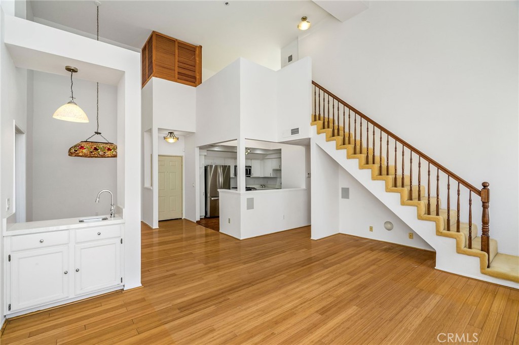 Welcome to your new penthouse unit at 5420 Sylmar Ave, Unit 321, in Sherman Oaks! This inviting and spacious third-floor residence features vaulted ceilings and an open floor plan unique to top-floor living. Upon entering, you'll find a welcoming living and dining area with a fireplace, two-story ceilings, and sliding doors leading to a balcony overlooking the courtyard.
The living room also includes a built-in wet bar and wired connections for a home theater setup. On the main floor, there are two roomy en-suite bedrooms. The primary bedroom features built-in bookshelves, two closets (including one walk-in), and a spacious bathroom with a sit-down vanity and a large tiled soaking tub.
Upstairs, the loft area provides additional versatile space ideal for an office or bonus room, accompanied by extra closet storage. This loft opens onto a second covered patio on the building's rooftop, offering another comfortable outdoor space.
The unit includes two parking spaces within a secured garage. Residents have access to the building's amenities, including pools, spas, barbecue areas, and exercise rooms. Enjoy convenient living in a prime Sherman Oaks location.