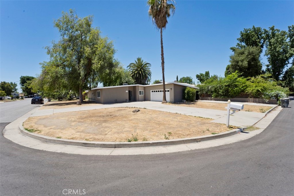Great looking home in centrally located neighborhood close to schools and shopping. This nice corner lot has two drive ways to make access very easy. The home has tile floors in the kitchen and bathrooms, new carpet in the bedrooms, Nicely updated restrooms with tiled tub and shower enclosures, Kitchen is large and very user friendly with granite counter tops and stainless steel appliances. The fireplace is adorned with beautiful tile and lots of character. The large patio leads to a nice shaded inground pool ready for the summer. This one will go fast make your appointment to see this one today.