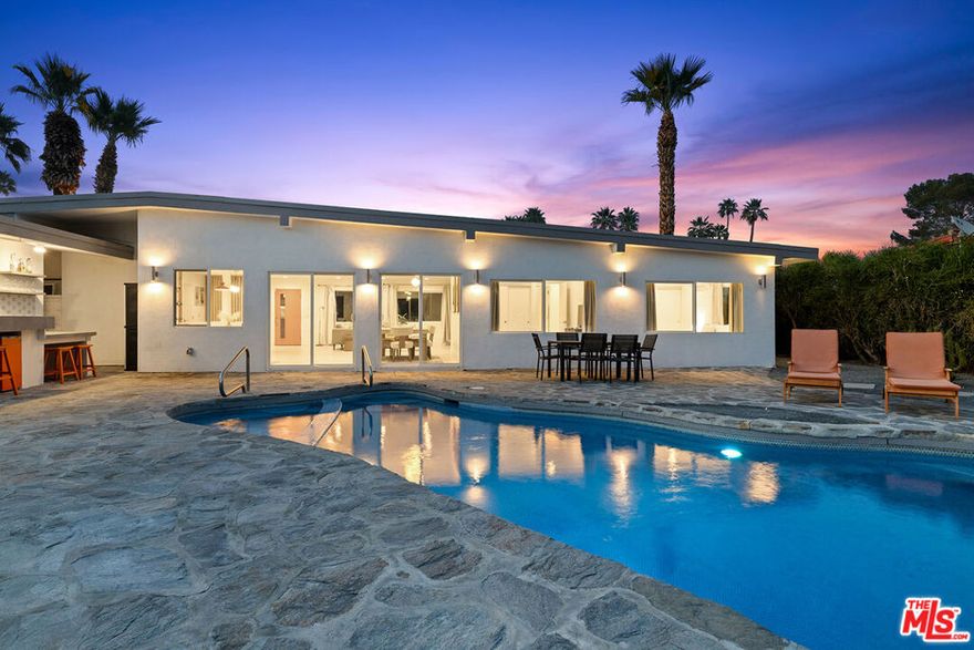 Unique opportunity in South Palm Desert to own a fully renovated Mid Century modern home with clean architectural lines, curb appeal, and tastefully restored with integrity to its original design while upgraded for modern living. This home sits on an expansive 10,890 sqft lot with great mountain views featuring 4BD 3.5BA in the main house plus a fully permitted ADU (462 sq ft approximately) with a full bathroom + kitchen that could be used as a Guest House, Pool House, or Income unit. The bright and open floor plan is equipped with a stunning kitchen that features SMEG Appliances, quartz countertops, an oversized custom skylight, top of the line custom cabinets with floating shelves and LED lighting, brass VIGO faucet, polished marble mosaic backsplash, and brass gold pendants sitting over a spacious waterfall edge island. A slatted wood panel wall on one side and a breakfast nook on the other complete this open concept. A formal dining area sits off a sliding door which leads to an entertainer's backyard that features a spacious tiled pool/spa, a floating sundeck, outdoor dining area, bar area, propane firepit, LION 4 burner grill, putting green with a turf area, desert landscaping surrounded by tall green hedges, DG, palo verdes, cactuses, lemon tree, agaves, golden barrels, and low voltage landscaping lighting. The floors in the living area are matte porcelain tile which continue on to the spacious bedrooms and junior primary suite with an en suite bathroom. The oversized primary bedroom has a nice separation from the other bedrooms on the opposite wing of the house. The primary has its own enclosed patio with a decorative vintage fireplace and beautiful tile as well as an oversized bathroom with a shower and a freestanding soaking bathtub, dual vanities, and a skylight. Other features include a powder room with festive tile and wall paper, pocket door, leased solar panels, custom doors, VIGO bathroom faucets, floating vanities, recessed lighting, light dimmers, brass modern door handles, new HVAC system with two additional mini split units, NEST thermostat, new water heater, new windows, electrical upgrades, plumbing upgrades, and many structural upgrades. A wellness area with a barrel sauna and cold plunge are well appointed in the backyard. Large parking driveway with a carport and Tesla EV charger! Close proximity from the best restaurants and shopping at El Paseo. Great golf courses like Vintage, El Dorado, Shadow Mountain, and Indian Wells are all a golf cart away. Listing Agent is the owner. No HOA's!