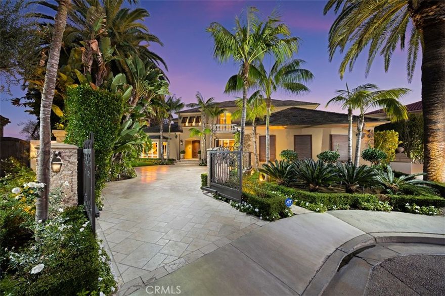 Inspired by the unhurried elegance of the French Riviera, 6 Windemere rises above the Pacific with a calm confidence and elevated coastal style. Set behind private iron gates on an oversized 15,600 SF corner parcel, the residence enjoys sweeping views of the ocean, Catalina Island, and sunset horizons. Inside, 5,364 SF of living space balances sophistication and ease. Vaulted ceilings, clerestory windows, and stone flooring draw in natural light throughout the day, while the great room and chef’s kitchen open seamlessly to a broad covered terrace and shaded pergola - a setting that recalls long lunches and late evenings along the Côte d’Azur. The backyard is the estate’s signature: a rare, expansive, level lawn framed by mature palms and citrus, a heated pool and spa, built-in BBQ, and a poolside pavillon with fireplace and television. It’s a private outdoor world designed for both quiet moments and glamorous gatherings under the California sky. Additional features include a 3-car garage with EV charging, infrared sauna, main-level guest suite, and zoned climate control. Minutes to Crystal Cove, Pelican Hill Resort, Fashion Island, and top-rated schools. Riviera elegance, tailored for Southern California living.