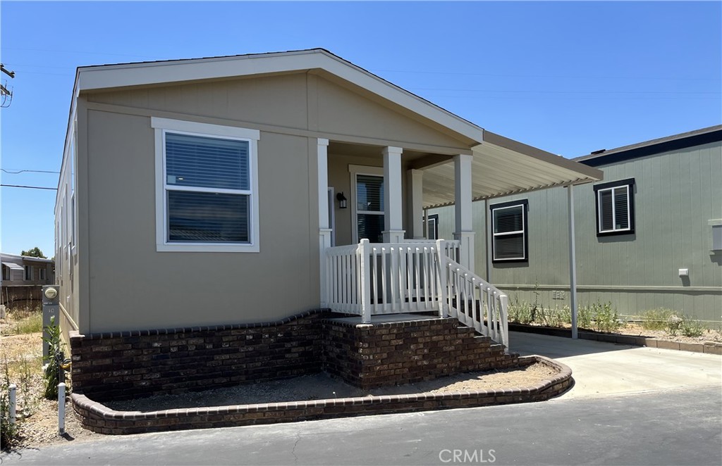 A Brand New Manufactured Home in a Senior Community/55+ Foothill Village. This 2-bedroom and 2-bathroom home has an open floor plan and is approx. 1040 sq. ft. The kitchen is equipped with stainless steel appliances: dishwasher, built-in microwave oven, refrigerator, and oven/range. The laundry room is steps away from the kitchen and has hook-ups for a full-size washer and dryer. The primary bedroom has an adjoining bathroom with a walk-in shower. The home has central a/c and heating, and an attached covered carport.