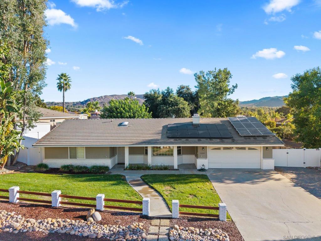 Welcome to this beautifully maintained 3-bedroom, 2.5 bathroom home nestled on a quiet cul-de-sac in the serene San Diego Country Estates. With 1,756 sq ft of living space, this ranch-style farmhouse offers an inviting open floor plan with a cozy brick fireplace, spacious laundry room, and a generously sized primary bedroom retreat. Step outside to your expansive backyard, perfect for animal lovers and outdoor enthusiasts. The property backs directly to horse trails and offers ample room for animals, gardening, or even future projects. Enjoy mature fruit trees and the peaceful country lifestyle right from your own yard. This home also features a permitted well for irrigation, a propane backup generator with automatic switch, and two solar systems, one fully owned and one under a Solar Purchase Agreement. Additional comforts include a whole house fan, gas furnace, electric A/C, and a newer gas water heater, making this home both efficient and ready for all seasons. A rare opportunity to own a well equipped home with land, privacy, and all the modern upgrades, don’t miss it!