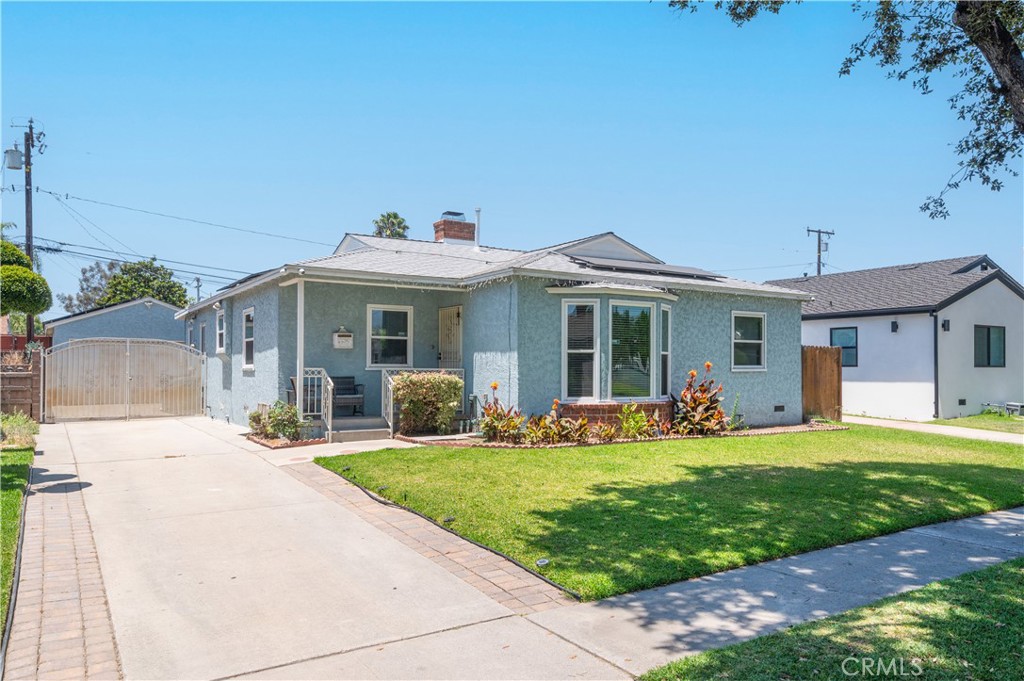 Welcome to 10125 Gridley Road, a beautifully maintained and partially remodeled home in one of Santa Fe Springs’ most desirable and family-friendly neighborhoods. This East-facing gem features 3 spacious bedrooms and 2 upgraded bathrooms, plus a generously sized bonus room that has been smartly divided to create a flexible 4TH bedroom or ideal home office. The updated kitchen, dual-pane windows, central A/C, and large covered patio with built-in ceiling fans make this home perfect for comfortable living and year-round entertaining. The long gated driveway leads to a detached 2-car garage, offering ample parking and privacy. Located just minutes from shopping, dining, and with easy access to both the 5 and 605 freeways, this home is also situated within a highly rated school district—making it an excellent choice for families seeking both convenience and community.