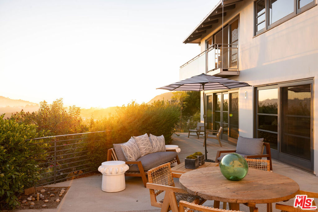 This stunning Hollywood Hills residence, designed by Frishman Architecture, is nestled within an exclusive, gated community. The recent renovation expanded the home from 2509 sq ft to 3109 sq ft and now features 4 bedrooms, 4 baths, and a powder room set across two floors, in an open living plan. A highlight of this property is its breathtaking views. Each room frames picturesque scenery, showcasing the glittering Downtown Los Angeles skyline and dramatic westerly views that peek over Lake Hollywood. The sunsets are particularly spectacular, casting a "persimmon light" that bathes the home in a golden glow and imparts a "pink hue" as the city lights begin to twinkle. This Hollywood dream home offers an up-close view of the iconic Hollywood Sign and features a separate music studio for creative pursuits. A must see in person home. Call for your personal tour.