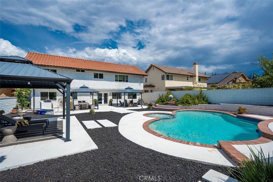 Mid-century Modern, meets West-LA, and dances with the additional luxury of nearly 1/4 acre of Rancho Mirage grounds with this extraordinary, unique, property. Rare: NO HOA or suffering Mello-Roos. Brilliantly remodeled in the highest of upscale taste: Kitchen, every bath, bedroom, living space upgraded to beyond contemporary. The photos tell a thousand words…From thermo-reflective exterior paint, and highly UV reflective interior shades, to insurance and drought friendly grounds… the Drone photos alone recognize the privacy of the enormous entertainers pool, spa, built in BBQ, 3 cabanas …and a meandering up-slope path to the view deck of the property. The chic’ interior welcomes, with a customized living room and fireplace that should be in “Modern Design.” Next, a kitchen like none other. Every efficient luxury appliance. The family room views out to the resort grounds. Family and guests can retreat to a full private downstairs bath and bedroom suite, with additional nearby hall closets. Upstairs hosts every contemporary remodeled upgrade “wow” as well. Especially the baths and closets. The primary suite is done with beyond exquisite taste.
