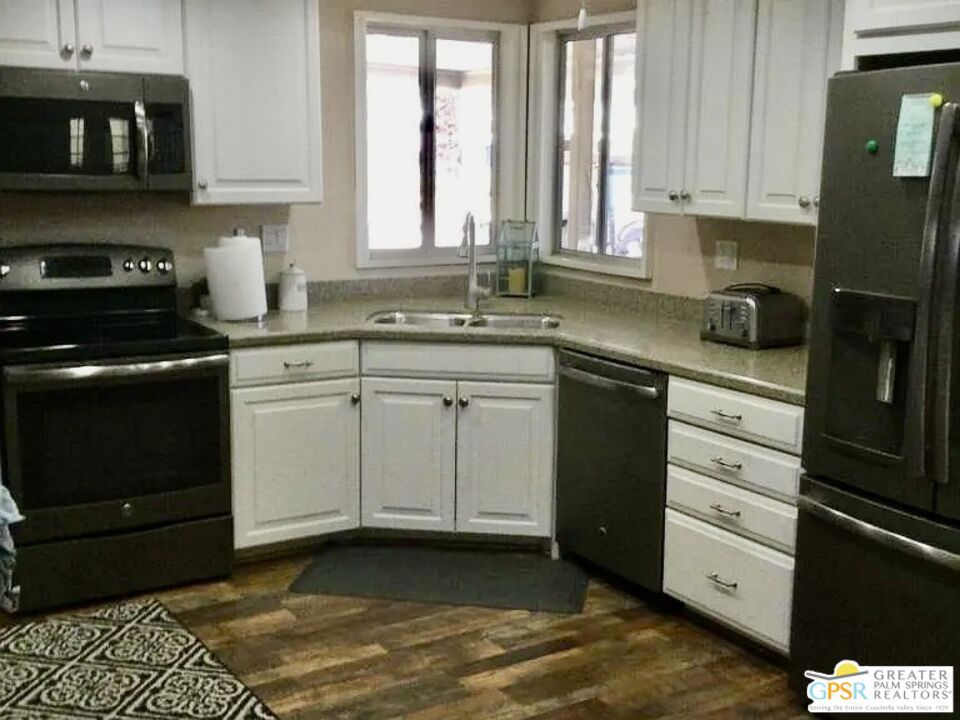 FURNISHED Remodeled Home!! Large 2 Bedroom 2 Bathroom, (12 month LEASE) wonderful REMODELED Kitchen with Corian Counter Tops, NEWER stainless steel appliances with Breakfast bar-- Large family room with wet bar. NEW WASHER and DRYER!!! This Manufactured home is in a 24 hour gated community of Palm Desert Greens Country Club, an 55 years and older community! The kitchen has been completely remodeled with corona counter tops, newer cabinets, and newer stainless steel appliances. Each bedroom features on-suite bathrooms! Lovely home with built in desk/bookcases and Laundry room with NEW Washer and Dryer! Private covered patio area off of LARGE Family room!! Side by Side 2 Car Covered Carport for easy access parking!! Enjoy all the amenities of this great community including Pickle Ball, Bocce Ball, Tennis, Swimming Pools, Exercise Room, and Clubhouse with restaurant. Come enjoy the community for a 55 yr. and older!