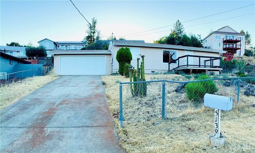 Opportunity knocks in one of the area’s most desirable neighborhoods. This 3-bedroom, 2-bath manufactured home sits on a large, fully fenced lot with sweeping lake views and a quiet, low-traffic road. A spacious detached garage provides excellent storage or workshop potential.



Inside, the home is a true fixer upper—ideal for buyers ready to add sweat equity or investors seeking a high-value location at an entry price. Whether you renovate for personal use or hold as an investment, this property’s setting and neighborhood values make it a smart move.



Bring your vision and unlock the full potential of this well-located property with space, privacy, and room to grow.