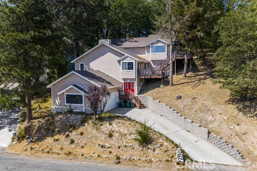 This beautiful fully furnished bi-level home is nestled in Running Springs within the San Bernardino National Forest, and as soon as you lay your eyes on it, you’ll immediately recognize the owner’s true “Pride-Of-Ownership.” Here are just a few of its many other fine features: Custom double doors swing open to a flowing 2,424 square foot open concept floor plan that is in “Move-In-Condition” with recessed lighting, a designer paint scheme, and a complementary blend of plush carpet and laminate flooring. The stairs bring you up to the spacious living room with direct deck access, a majestic gas-burning fireplace with raised hearth, and entertainer’s wet bar with custom pendant lighting. The family’s cook is going to fully appreciate the kitchen’s large garden window, abundant cabinets, ample Corian counters, durable dual basin stainless steel sink, built-in appliances, breakfast bar, and the convenience of the adjoining dining area. Since the family room with its bright skylight, direct deck access, and stacked stone gas-burning fireplace with raised hearth flows seamlessly with the dining area, you’ll find it easy to serve and entertain your guests simultaneously. All 3 bedrooms have efficient mini split AC units. The grand suite also has a large skylight, walk-in closet, and a beautifully appointed bathroom with large dual sink mirrored vanity. The bonus room could be used as your 4th bedroom or office. There is a total of 2.5 bathrooms and functionally located laundry room with handy utility sink. Energy efficient dual pane windows will help keep your utility bills low. Plenty of secure parking on the oversize concrete driveway and in the 2-car direct access garage. All of this sits on a large 9,940 square foot lot that is minutes away from restaurants, Running Springs Fine Foods, the Farmers Market & Artisan Faire, Santa’s Village, Big Bear, Lake Arrowhead, and Snow Valley Ski Resort. Perfect to use as vacation home or use it as Airbnb if it is not used by the owners. Sellers are planning to do a 1031 Exchange. Buyer to cooperate with sellers' 1031 Exchange at no cost to buyer. Call now for all the details and I’ll gladly arrange your private tour.