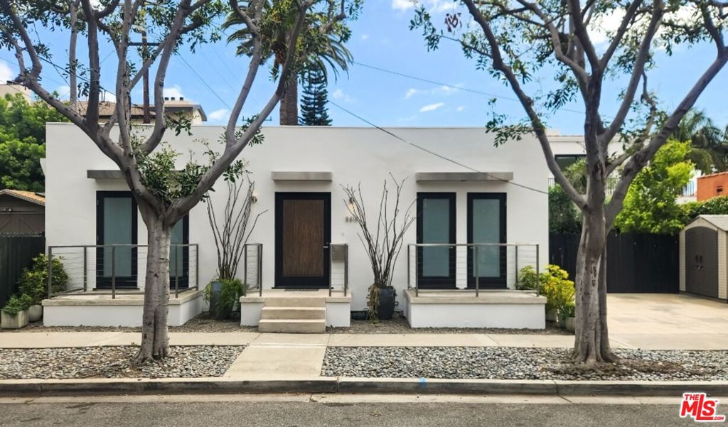 Enjoy a luxury lifestyle in this remodelled two-bedroom, 2.5 bath with convertible den (or 3rd bedroom) in the heart of West Hollywood. It features a skylit Poggenpohl kitchen, a large center island with a gas cooktop, and a wine fridge. The primary bedroom has a private patio and a spacious bath with a separate tub and shower. Additional highlights include a formal entryway, off-street parking for two, dark wood floors with an open floor plan ideal for entertaining. The lush outdoor area includes a BBQ, a service counter with a seating area, a fire feature, and a serene fountain. This contemporary gem is near the boutiques on Beverly, the vibrant cafe culture on Melrose, the Design District, and world-famous restaurant