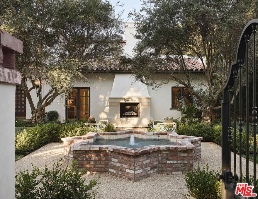Casa Veleta is a reimagined Spanish jewel created by the renowned luxury home design and build partnership of Aeries Development and AMG. Fresh from a total renovation completed in 2025, classic 1920's details embrace modern day conveniences. Behind a high hedge and past a wrought iron gate, a glamorous fountain and outdoor fireplace invoke historic Montecito. The courtyard sets the stage for a sensory experience beyond. Bathed in light, the entry stair hall and all interior walls are clad in hand-troweled plaster masterfully crafted by artisans. A grand living room with vaulted ceilings is ideal for large-scale entertaining. Elegant formal dining and wine rooms open to an outdoor kitchen and dining area. A gourmet kitchen with oversized marble island and banquette seating opens to a vast terrace and pool beyond. The primary suite is a world apart, with large marble bath, retail quality closet, and a wall of French doors opening to a private terrace with fire feature. Three additional bedrooms (with walk-in closets and en-suite bathrooms) and a common terrace space complete the upper floor. Additional features include a private office (or generous fifth bedroom) with fireplace and full en-suite bathroom, a complete chefs/catering kitchen, a gym/wellness room with sauna that leads directly out to the pool and hot tub, and a gorgeous separate guest villa/ADU. This is an exceptional opportunity to own a piece of living art on the prized 600 block of Arden. Surrounded by important estates, this is hands-down one of the finest locations in Beverly Hills. Casa Veleta is a rare gem for the most discerning buyers.