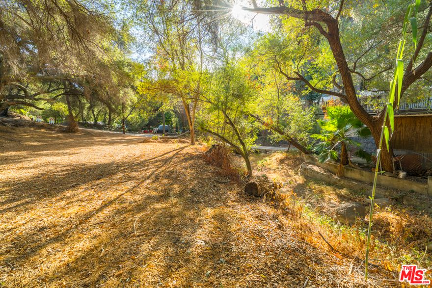 Tranquil Lot with Seasonal Creek and Oak Trees. Discover a serene slice of nature in the heart of Topanga. This unspoiled parcel, located just off Topanga Canyon Boulevard, features a seasonal creek, mature oak trees, and a peaceful, woodsy setting. Ideally situated between Malibu's beaches and the San Fernando Valley, the lot offers privacy, charm, and a rare opportunity to own land in one of Los Angeles's most storied and sought-after communities. Whether you're looking for a nature retreat, a long-term investment, or a foothold in Topanga Canyon, this property invites imagination. Buyer to independently verify zoning, build-ability, and all potential uses. Seller financing available for qualified buyers: 7.5% interest-only payments for up to 5 years. Submit all offers.