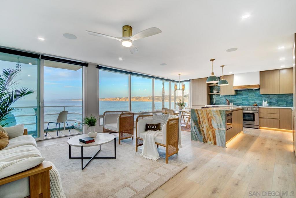 Seller will entertain offers between $2,599,000 and $2,649,000 - Discover unparalleled luxury and coastal sophistication at 1219 Coast Blvd #3, an exquisitely remodeled 2BR/2BA condo perched directly across from iconic La Jolla Cove. This front-row residence offers breathtaking sit-down ocean views, spanning the expansive Pacific coastline with Torrey Pines cliffs in the distance. Designed for both elegance and comfort, the open-concept layout is bathed in natural light, seamlessly integrating contemporary finishes with the beauty of the panoramic ocean views beyond. The gourmet kitchen is a chef’s dream, featuring a professional-grade range, built-in dishwasher, and French door refrigerator, all set within sleek, modern cabinetry. A double-waterfall quartz island, designer tile backsplash, and ambient toe-kick lighting create a striking centerpiece for both cooking and entertaining. Smart home features include iPad-integrated blinds, lighting, and surround sound, allowing you to control ambiance with the touch of a button. Spa-inspired bathrooms boast designer tile showers, smart bidet toilets, chic fixtures, and floating vanities. Stylish LVP flooring, mini-split AC/heat, and in-unit laundry offer modern convenience. Set within an exclusive 6-unit boutique building with low HOA fees, this coastal gem includes secured garage parking and a private storage closet. Experience the finest coastal living in America’s Finest City.