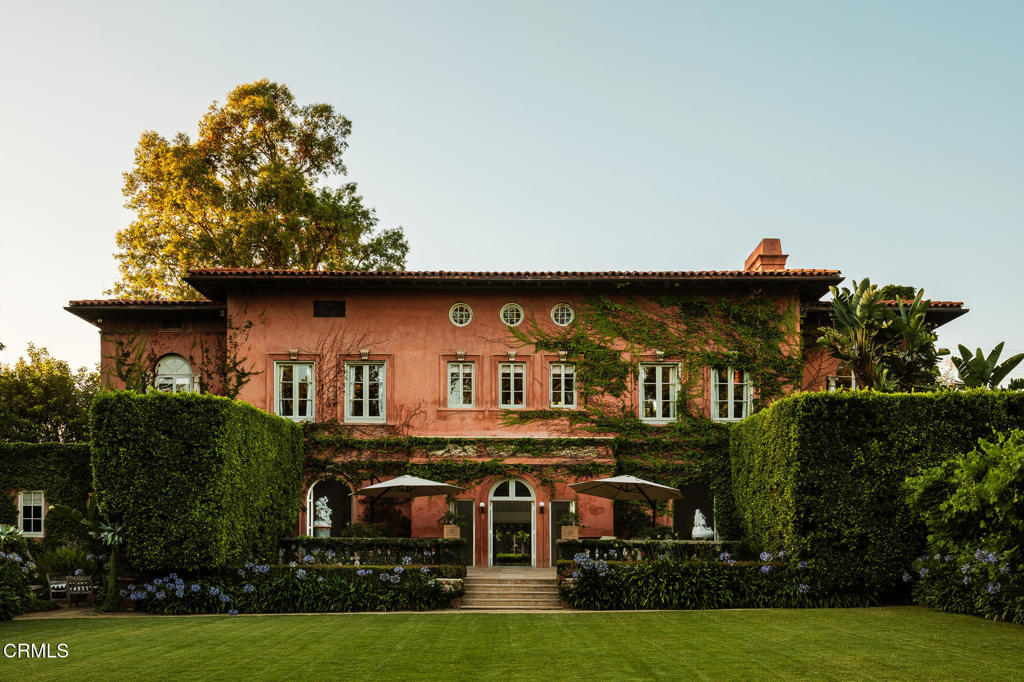 Secluded behind the original estate walls, this classically inspired Tuscan villa sited on a flat one acre parcel in the coveted South Arroyo neighborhood of Pasadena and South Pasadena. Designed by noted architect Reginald Johnson - featuring the principal residence, sequestered guest house, verdant grounds, grand pool and captivating gardens. A mix of the structured and elegant Italian Renaissance Revival, with a more approachable, relaxed living environment that embraces the necessities and desires of today. Owned by Pasadena luminaries for nearly a century, and now the home of an acclaimed fashion designer and his wife since 1998 - the 5-bedroom, 5-bathroom primary residence features voluminous space and height throughout with equally scaled original Palladian doors and windows which provide an abundance of light and air. Honed marble, rich plaster, period woods and premium paint finishes provide the material palette. The entry gallery with classical columns acts as an initial gathering space for the grand public viewing and entertaining areas: formal living room and adjoining library - both with fireplaces, powder room, and a formal dining room. All have direct access to outdoor patios, gardens and the expansive lawn beyond. Chef's kitchen and great room with casual seating and an adjacent butler's pantry. Catering prep, separate laundry room, two bedrooms and bathroom complete the lower level. The second level is divided into two distinct zones accessed from the central landing. Luxurious primary suite - with separate bedroom, dressing and sun rooms and walk-through closet and bath. Opposite is an additional bedroom suite with bath ensuite and adjoining sitting room, as well as an executive bedroom with bathroom and closet ensuite. Private one bedroom guest house with living room anchored by a fireplace, kitchen, bedroom and bath - all surrounded by its own hedged gardens. Swimmers pool, spacious pavilion, spa retreat, hidden rose garden and dining area with fireplace and grill. Lushly landscaped with sweeping lawns, mature specimen trees, secluded refuges and abundant water features. Motor court and carport for multiple vehicles. Viewing garden. An extremely private and exclusive offering.