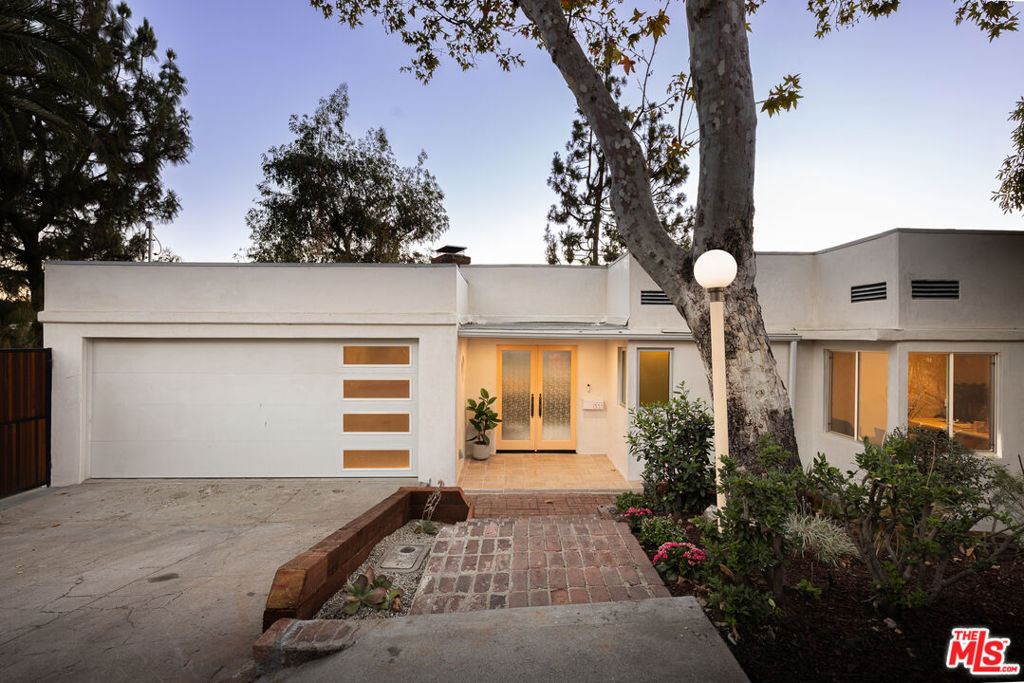 Architecturally significant 1936 Streamline Moderne The Frank Baudino House fully restored in an extensive multi-year renovation. Originally built for Glendale's former three-time mayor, this example of increasingly rare Streamline Moderne design has been meticulously revived with a blend of era-accurate antiques and restored pieces, intentionally calling on the streamline motif. Perched on Adams Hill with panoramic city and mountain views, the two-story home showcases a spectacular living room with decorative fireplace, custom shelving, and a curved wall of restored casement windows and doors opening to a wraparound Travertine-tiled deck. The chef's kitchen features custom solid cherry cabinetry, top-tier appliances, center island, and built-in cherry wood banquette, with Fleetwood sliding glass doors to a large deck ideal for al fresco dining. Two bedrooms and a period-accurate hall bath complete the upper level. Downstairs, two private bedroom suites flank a dramatic entertainment room with rounded wall, built-in white oak wet bar with restored original bar stools, and decorative fireplace with handmade tile surround. Bathrooms feature custom bespoke tilework; one includes a cedar sauna. All open to a lushly landscaped private yard with more views. Also, a two-car garage with laundry. Just down the hill, the property is a short distance from the endless offerings of Glendale, Atwater Village, Eagle Rock, Highland Park, with shops, restaurants, entertainment, freeway access, and so much more. CLICK ABOVE "DOCS" TO SEE DETAILS OF THE RESTORATION/UPGRADES.