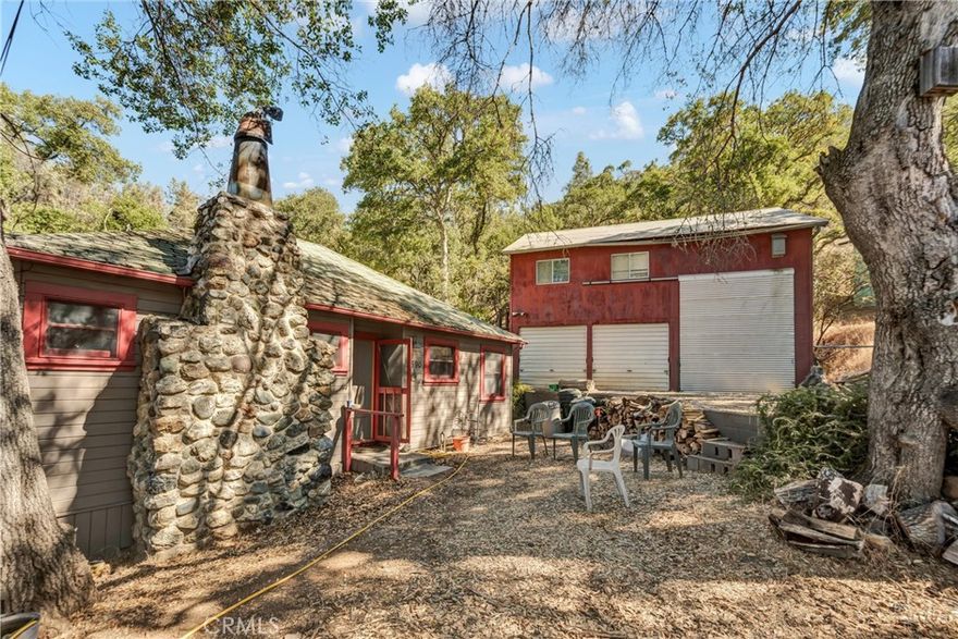 Welcome to this charming 3-bedroom, 1-bath cabin, set on a spacious 13,067 sq. ft. lot. Bursting with character, this home features custom trim and molding throughout, redwood-cased windows, and classic "lawyers wood" walls that add timeless warmth. A striking cobblestone fireplace anchors the living space, while new waterproof laminate flooring provides modern durability with rustic charm.

The property includes a detached garage with both a 1-car bay and a dedicated RV spot, plus convenient boat storage tucked beneath the home—perfect for adventure seekers. Adding to its appeal, this home offers year-round neighborhood beach access, giving you a place to enjoy the lake in every season.