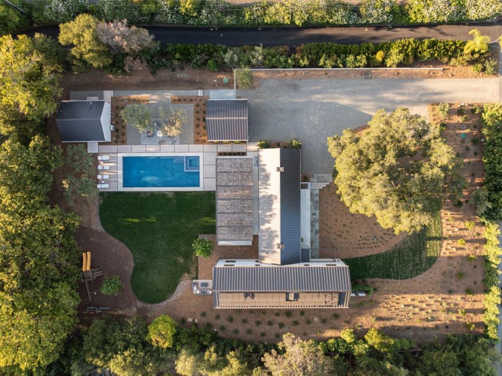 LESS THAN ONE MILE FROM THE LOS ALTOS VILLAGE, this just completed home exudes a European modern style on a fully level lot of more than 1.1 acres. The entire property epitomizes luxury & sophistication, featuring exceptional details & unparalleled craftsmanship rarely found at this level in new construction. The homes sleek towering lines & standing seam metal roof make a commanding first impression beyond a crushed stone motor court that gives a nod to its European ambiance. The main residence spans two levels with San Francisco Bay views from the upper level & a central great room that serves as the heart of the home. The interiors are designed with impeccable taste and a commitment to high-end finishes & attention to detail that set a new standard. Hand-painted electrical outlets, curbless thresholds throughout, & a floating lighted staircase that stands as an architectural work of art exemplify this commitment. Indoor/outdoor living is a signature of the design with a vast willow covered steel arbor defining dining & lounging beside the pool & spa. A sweeping lawn offers wonderful space for recreation & entertaining & just beyond, the fully equipped ADU unfolds with matching quality. Total of ~6,704 SF; House 4,195, ADU 526; Garage 483; Storage 105. Rear & front patios 1,395
