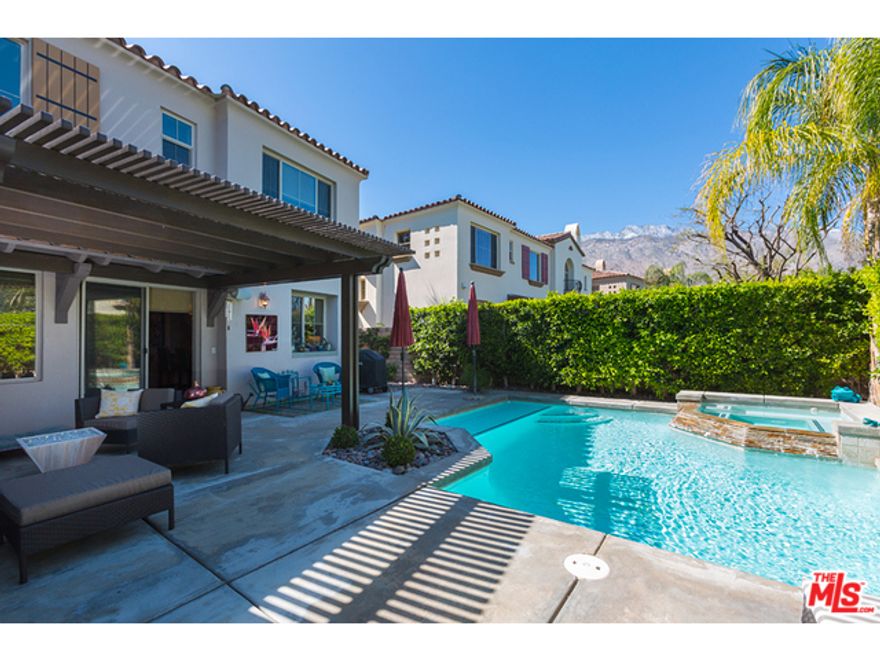 Showcase designer condo with private pool and spa shows and shines like a model! Located just a few blocks from downtown Palm Springs, this gated community includes two community pools and spas, outdoor BBQ and dining areas, and park-like grounds. Entertain in the light and bright gourmet kitchen that opens to the living room which has two story ceilings, a gas fireplace, built-in speakers, bamboo flooring and direct access to the private backyard, pool, spa and covered entertaining area. There is also a formal dining room which could be converted into an office or third bedroom as well as full bath with walk-in shower, too. Upstairs, you will find an open balcony that looks down onto the living area and two Master Suites each with private baths. Master Suite One has dual sinks and a generous walk-in shower. Master Two also has a private bath with a shower/tub combination. Attached two car garage. Clearly, this one is a winner!