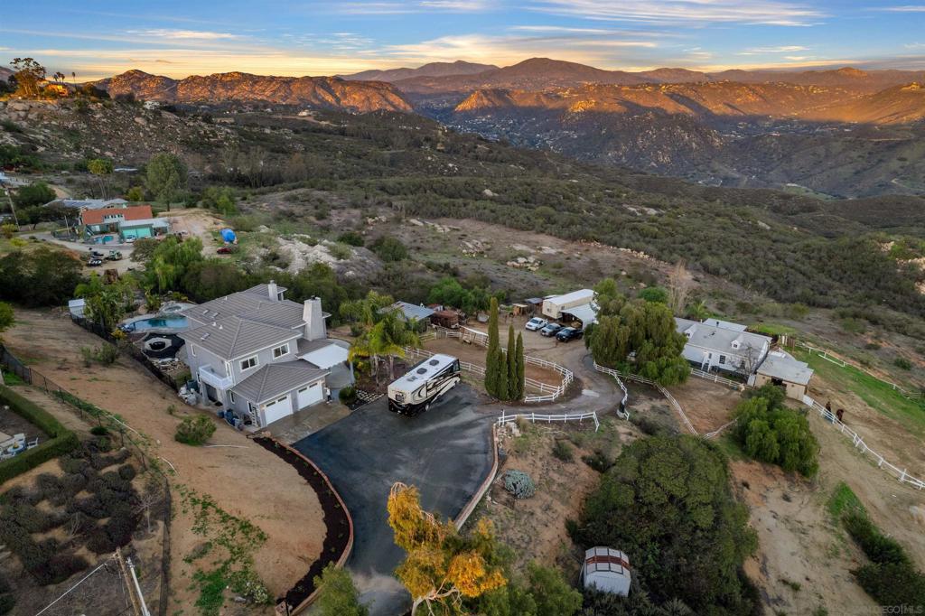 !NEW PRICE...Variance granted Detached...Unique Horse Property with FOREVER VIEWS...Two Detached homes on 3 acres...Step into a living postcard of natural beauty & timeless simplicity. Welcome to this small town community, perched high above the expansive Dehesa Valley & overlooking Singing Hills Golf Club. The views from 410 & 412 Woodland Ln are nothing short of breathtaking with an unspoiled canvas of rolling hills, natural beauty & diverse wildlife. Crest CA isn't just a place to live; it's an experience, a lifestyle; it's nature's playground. Offering unparalleled peace and quiet, you cannot put a price tag on. The best of life's simple pleasures; biking down dirt roads with the wind in your hair, riding horses through wide open fields, building forts in the woods, and tying ropes to trees to create the perfect swing with besties. An atmosphere full of innocent adventures—catching pollywogs in streams, chasing butterflies thru the forest trees, & simply living life outside, without electronic distractions where the days seem endless. With 3,000 residents, Crest still retains its small-town charm, where neighbors know each other by name & the community spirit is strong. If you long for the simple life—where kids play freely, horses can frolic, and the sounds of nature surround you—look no further than 410-412 Woodland Ln...a rural mountain retreat offering more than just two homes; It offers a lifestyle—a chance to escape the hustle and bustle of city life and live in a place where peace, simplicity, and natural beauty reign supreme. Crest, CA…Small town with big hearts. Main house is 2,337 sf w/3 bedrooms, 4 Baths, 3-bay garage, heated pool/spa w/waterfall, large usable 3 acre property, breathtaking picture window views, high ceilings, multiple french doors open to outdoor space, two wood burning fireplaces, open concept kitchen w/custom cabinets, SS 5-burner gas stove, double oven w/warmer, separate island w/additional sink, granite countertops, dining room features wet-bar w/porcelain sink & built in wine-glass storage. Oversized Primary Suite w/BIG views from private balcony. Primary bath w/dual sinks, porcelain tile, spa tub w/heated jets, walk-in closet. 412 Woodland Ln 2nd home (ADU) is detached pre-fab home w/separate address, own SDGE meter, 1,300sf 3 bedrooms, 2-baths, wood burning fireplace, large covered deck w/BBQ & Bar area perfect for outdoor dining & entertaining, breathtaking views, property currently housing approx 11 horses. 2nd home may qualify as rental income w/lender. Property is on city water and both have own septic systems. Horse Facilities: 3-Stall barn w/feed storage, 2-Stall Mare Motel (negotiable), 120x40 Arena, 4-pastures, overlooks a preserve of open land. Trails nearby, Equestrian center is located just a couple blocks away at S. Lane Cnty Park. Property offers ample space for RV-Trailers-Toys parking. The expansive grounds offer endless possibilities, including a multi-family compound!