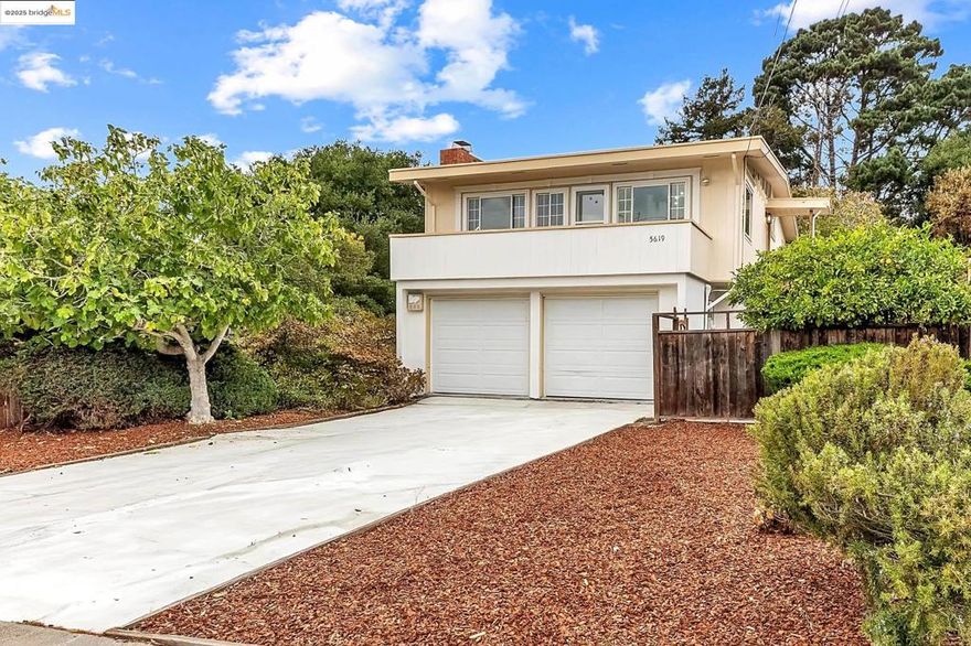 Welcome to 5619 Doremus Ave, a bright and versatile Lower Mira Vista home with mid-century charm! This 4BD/2BA blends timeless character with fresh updates: painted kitchen cabinets, new stainless-steel appliances, updated fixtures, and interior paint. Main level features an open floor plan with hardwood floors, spacious living room with fireplace, light-filled kitchen/dining, and seamless flow to the outdoor patio—ideal for entertaining. Three bedrooms and full bath complete this level. The lower level offers a huge living/family room, bedroom, bath, and separate entry—perfect as in-law, guest suite, or income rental. Front/back yards include new mulch, storage shed, and mature fig & lemon trees. A 2-car garage with internal access, shelving, indoor mailbox, and an extra-long driveway for 4–6 cars add convenience. Near Mira Vista Elementary/El Cerrito schools, shops, dining, trails, and I-80—peaceful living with city convenience!