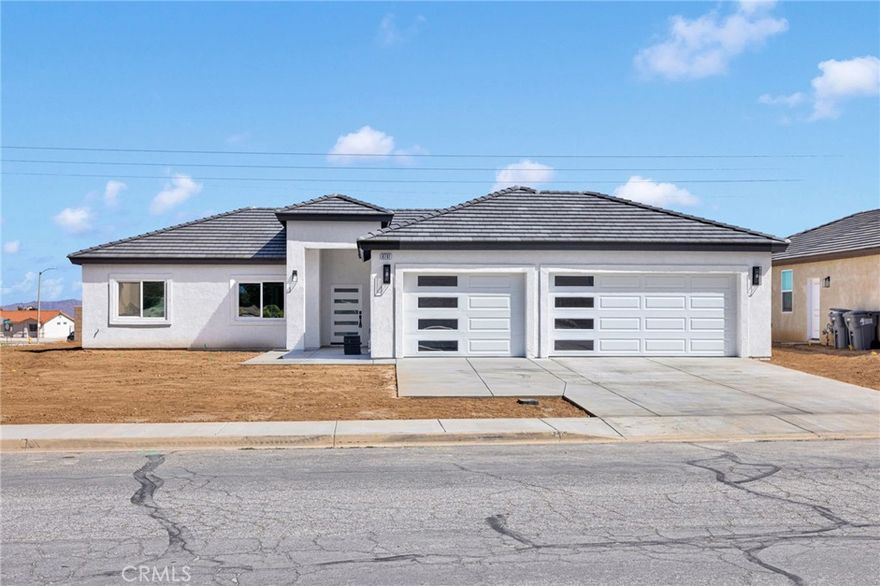 Brand New Construction Home in a very sought out area of Hesperia! Close to all Off Roading fun. ---NO H.O.A...... NO MELLO- ROOS TAXES LIKE ALL THE OTHER NEW COMMUNITIES BEING BUILT!!!!----Featuring paid OFF solar, This home has beautiful style elements with modern designs for unparalleled living which included tiled walls. The living area is flooded by natural light with a beautiful fireplace as the focal point also featuring an open layout design to the kitchen. Step into the modern kitchen with new soft-close cabinetry, Quartz countertops, accented by stunning tile backsplash, stainless steel appliances, a walk-in pantry, and a large center island. High ceilings, stunning ceramic tile flooring flows throughout the home, and so much more! This home boasts 4 beds, 2 bathrooms, 1729 sqft, BIG deep 3 car garage, Split floor-plan, and laundry room. The indoor laundry is equipped with quartz counter and plenty of cabinet space. Indulge in the master suite with an oversized walk-in closet, the master en-suite offers a custom tile walk-in shower, 2 shower heads, and dual sinks. The guest bathroom has been a stand-in shower and tub. Enjoy the backyard, covered patio, and make this BRAND NEW HOME yours!