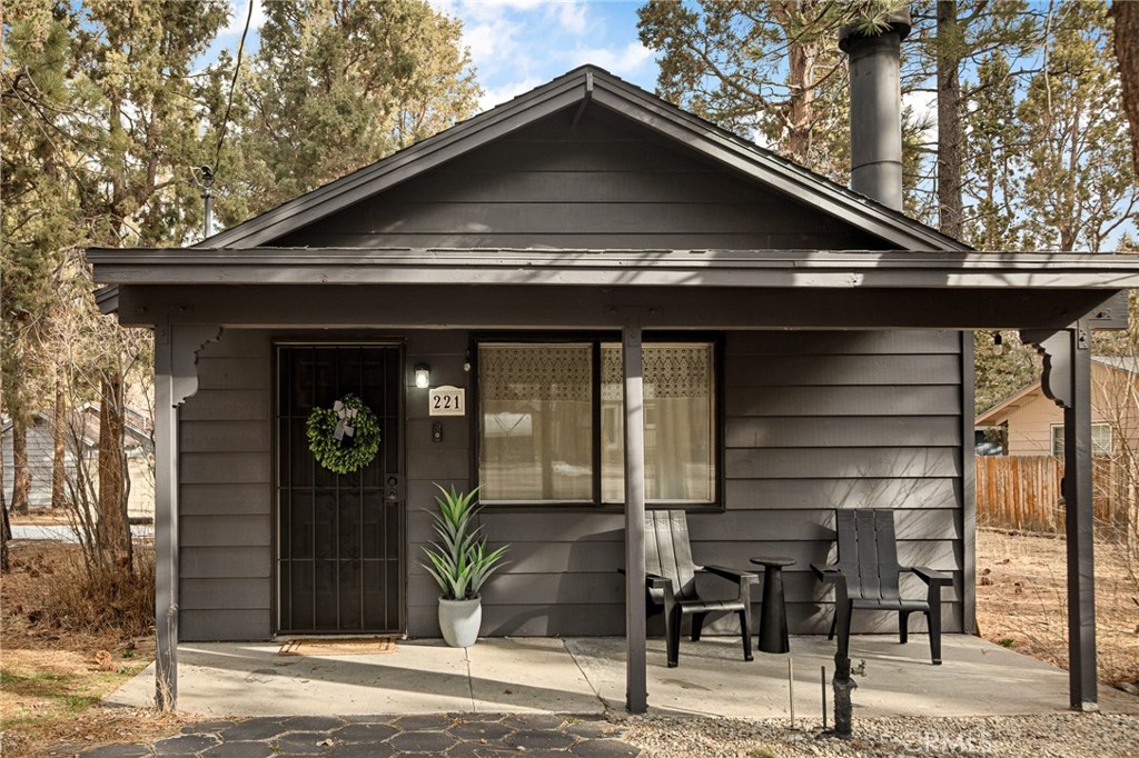 This stylish mid-century modern cabin blends retro charm with modern upgrades, making it the perfect short-term rental or private getaway in Big Bear. Nestled on a quiet street with serene mountain views, this home offers the ideal mix of relaxation and adventure. The open-concept living space features vaulted ceilings, a cozy brick fireplace, and large windows that flood the home with natural light and frame picturesque mountain scenery. The fully renovated kitchen and bathroom include brand-new plumbing, modern appliances, and a charming breakfast bar—perfect for entertaining. Both spacious bedrooms are thoughtfully designed with stylish mid-century furnishings, while the shared retro-inspired bathroom is conveniently located nearby. Outside, the newly enclosed yard offers a brand-new fence, freshly laid turf, and a concrete pad ready for a hot tub or fire pit, making it an ideal space for relaxation under the stars. Recent upgrades include new heater, new flooring, fresh interior and exterior paint, new locks, new exterior doors, and a roof in perfect condition. Whether you're looking for a profitable investment or a peaceful mountain retreat, this turnkey Big Bear cabin is ready for you!