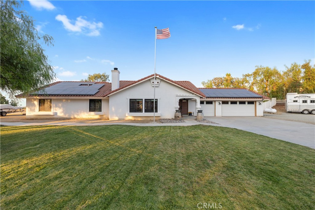 Welcome to this stunning home tucked away in the highly sought-after Equestrian Community of Gavilan Hills in Perris. Perfectly designed for those who value privacy, comfort, and equestrian lifestyle, this neighborhood offers private horse trails and a private arena reserved exclusively for homeowners.
From the moment you arrive, you are greeted by a manicured lawn and inviting curb appeal. Inside, Sterling Oak vinyl plank flooring flows seamlessly throughout the home, enhancing the light-filled, open floor plan. The airy kitchen features granite countertops and brand-new sliding doors, and a functional layout designed for entertaining and everyday living. Each bedroom is generously sized, while the bathrooms offer ample space, with ceramic tile countertops and upgraded Luxstone shower walls.
The family room is the heart of the home, complete with a brick mantle fireplace. Recent upgrades include dual-pane UV-reflective windows, new stucco and exterior paint, a new gate, and new garage doors. The garage has been thoughtfully converted into an office/gym with its own AC, providing versatile use for today’s lifestyle.
Step outside to your private backyard retreat, featuring a sparkling pool, relaxing hot tub, and a functional barn ready for your horses. With a property just shy of 2 acres and thoughtful upgrades, resort-style amenities, and true equestrian features, this home presents a rare opportunity to live your dream in Gavilan Hills.