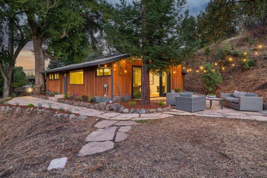 Sunlit Gem on Nearly One-Half Acre with Plans to Expand! Fresh, inviting, and completely sophisticated, this country retreat has been transformed into a light-filled setting. Easily accessed, the property spans nearly one-half acre of predominantly level grounds and includes plans for a future expansion. The current home, with 2 bedrooms and 2 baths, offers a streamlined scale yet the open concept design lends an unexpected sense of expansiveness. A crisp palette of whites defines the interiors, from the all-white kitchen with quartz countertops and subway tile backsplashes to the remodeled baths finished in marble and tile. Vaulted ceilings with skylights and exposed beams enhance the airy atmosphere, while wood-like luxury vinyl floors provide continuity throughout.  Multiple sets of glass doors open to wraparound flagstone patios and expansive land, where limited tree canopies allow brilliant sunlight to fill both the interiors and outdoor gathering spaces. Finishing touches include a separate laundry room, an outdoor storage shed, and a two-car carport. Portola Valleys acclaimed schools and miles of scenic trails are just moments away, making this a remarkable opportunity to enjoy contemporary style and comfort today with the option to expand in the future.