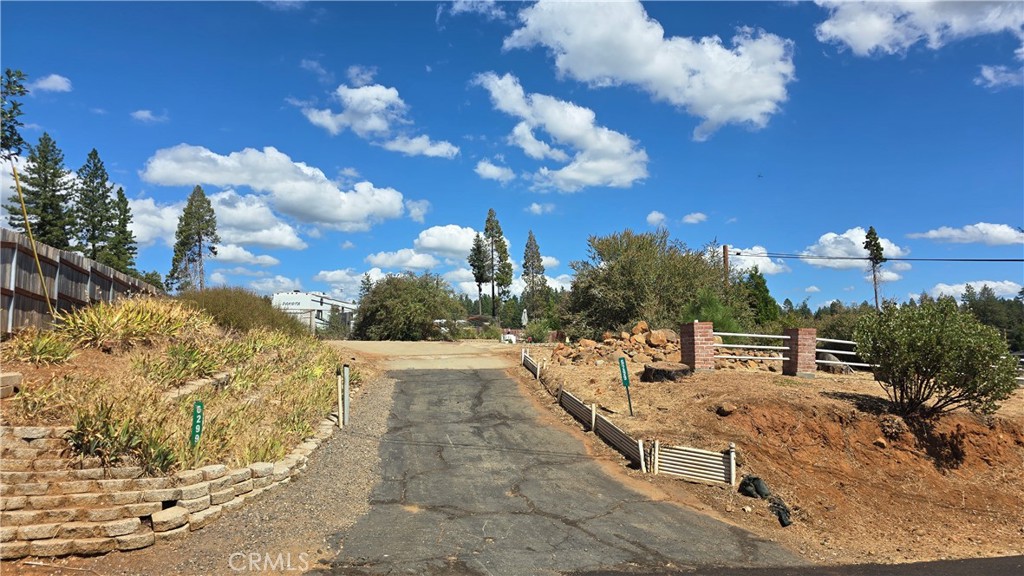 Elevated Corner Lot with Utilities & Mature Landscaping!  This gently elevated corner parcel offers a great opportunity to build your dream home in the heart of Magalia. The lot features existing brick and rail fencing, a partial concrete driveway, and mature landscaping including butterfly bush and other established plants plus raised garden beds still in place.  Power and water are available on the lot, making your building process even easier.  Ideally located just minutes from the clubhouse and only a mile from downtown Magalia, you’ll enjoy quick access to shopping, dining, and the post office. Spend your summer evenings enjoying free live music on the lawn at the nearby Magalia Community Center & Park.  Surrounded by lakes, rivers, hiking and riding trails, this lot is a perfect launching point for year-round outdoor adventure and peaceful mountain living.  It also offers a quick and easy commute via Skyway to both Paradise and Chico. For outdoor enthusiasts, this lot is a short drive from recreational opportunities such as fishing, water sports, and adventure in Paradise Lake, DeSabla Lake, Lake Oroville Marina, or the Feather River. The property's inclusion in the Paradise Pines Property Owners Association enhances its appeal & charm, offering access to amenities such as pickleball and bocce ball courts, a children's playground, hiking trails, a swimming pool and spa, a clubhouse with meeting rooms and a library, dual event centers with fully equipped kitchens, and a bar and lounge for special events and community gatherings. This lot represents the opportunity you've been seeking!