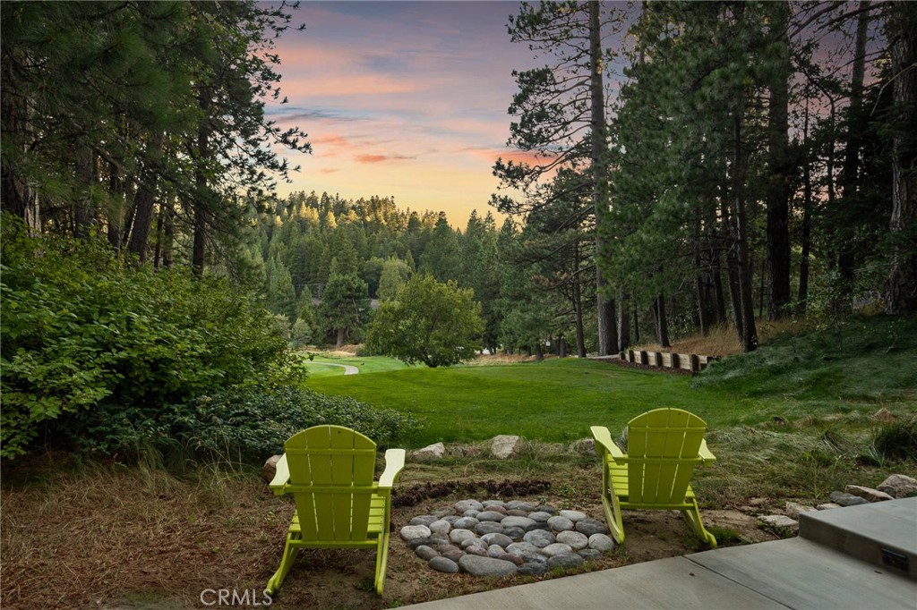 Where Mountain Magic Meets Modern Luxury
Welcome to an enchanting retreat tucked within the prestigious Lake Arrowhead Country Club, gracefully perched on the signature 16th tee box. Here, luxury living is kissed by the whisper of towering pines, the sparkle of mountain air, and the timeless allure of Lake Arrowhead—where your lake rights invite you to endless days of adventure on shimmering waters.
Originally reimagined in 2021 and remodeled again in 2025, this residence has been elevated with a collection of exquisite upgrades. Inside, new wood flooring flows throughout the home, while the master suite was transformed with plush new carpet, an enlarged walk-in closet, and a fully remodeled bedroom retreat. The kitchen shines with custom-painted cabinets, custom wainscoting, a gleaming new quartzite island countertop, and dazzling designer chandeliers in both the living and dining rooms. Fresh interior and exterior paint, along with striking new iron-and-glass entry doors, lend the home a crisp and refined elegance. In the living room and master suite, newly crafted stone fireplaces create warm, inviting focal points, and a whole-home water filtration system enhances everyday living with mountain-pure freshness. The main level embraces open-concept living, seamlessly blending living and entertaining spaces. At its heart is a chef’s dream kitchen featuring GE Café appliances and a magnificent Italian ILVE six-burner range. Three distinct gathering areas—including the celebrated Presidential Billiards Room and Cocktail Lounge—offer versatile settings for everything from cozy fireside evenings to lively celebrations with friends and family. With 5 bedrooms & 5 bathrooms, including two primary suites, there is ample room for privacy and comfort. Every detail has been thoughtfully considered, from dual-zone heating and A/C to upgraded plumbing, electrical, Anderson windows, and dual laundry stations. A state-of-the-art heated driveway system ensures you’ll never have to shovel, even during the fiercest winter storms. Stonework along the façade and driveway, rock-scaped landscaping, exterior lighting, and expanded parking add to the home’s mountain charm. A generator and dog run complete the thoughtful upgrades designed for ease of living. This is more than a home—it’s a lifestyle. A place where fresh 2025 upgrades, timeless luxury, and mountain whimsy come together to create a sanctuary that is as enchanting as it is functional.