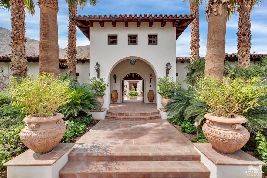 Got Cars!  8 car garage !  The Ultimate Hacienda Style Masterpiece! Sparing no expense, the owners traveled the world for the finest materials to create a Charles Howell architectural wonder. With fireplaces in all 4 Bedrooms, leather floor Office and a Don Quixote Bar, it is rich with fine detailing and dozens of antique doors - every room tells a story. Meander downstairs to an underground Living Room, 8 to 10-car garage & custom wood golf locker room. Built on one of the best lots in Tradition w/ south mountain views of holes 15 & 16. Truly a magical spot in the shadow of the famed Indians' Talking Rock where you'll spend your evenings with friends and family gathered around an outdoor fire pit and spacious rear lawn. With stunning courtyard, dual spas, towering Entry and Hallways, groin vault brick ceiling in the Dining Room, custom flooring from Spain, this Hacienda Style home with light and bright white walls will never go out of style. Offered partially furnished per inventory.