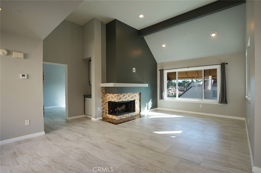 Beautifully updated 1-bedroom, 1-bathroom condo in the heart of Laguna Niguel. This upper-level unit offers privacy with no neighbors above or below. The open-concept living area features high ceilings, new flooring, and a cozy fireplace filled with natural light. The upgraded kitchen includes new appliances, cabinetry, and stylish countertops. The bathroom has been remodeled with modern fixtures and finishes. Additional features include an in-unit Level 2 (240V) EV charger. Conveniently located near Dana Point beaches, shopping, dining, and freeway access.