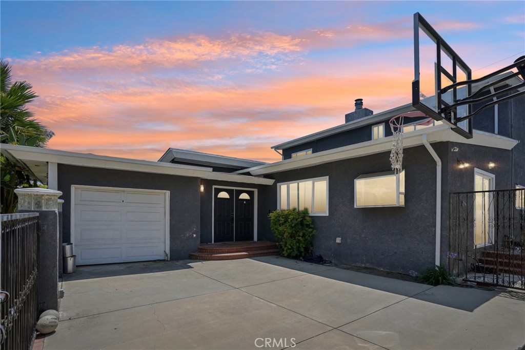 Stylish and spacious in the heart of the Plaza! This 5-bedroom, 3-bathroom home offers approx. 2,300 sq ft of thoughtfully updated living space with a flexible floorplan perfect for modern living. The open-concept main level features a light-filled living room, engineered wood floors, recessed lighting, and a beautifully remodeled kitchen with quartz countertops, custom cabinetry, a 6-burner range, and herringbone tile backsplash. Enjoy effortless entertaining with a large center island and adjacent dining area. Three bedrooms downstairs—including a main-level suite—and two upstairs, ideal for guests, teens, or a home office. Additional highlights include dual-pane windows, central heat & A/C, an indoor laundry room, and gated parking. The private driveway and courtyard offer room for multiple cars or play, while the lush backyard features tropical landscaping and space for outdoor dining or relaxing under the stars. Located near top-rated schools, shopping, dining, and El Dorado Park—don’t miss this move-in ready gem!