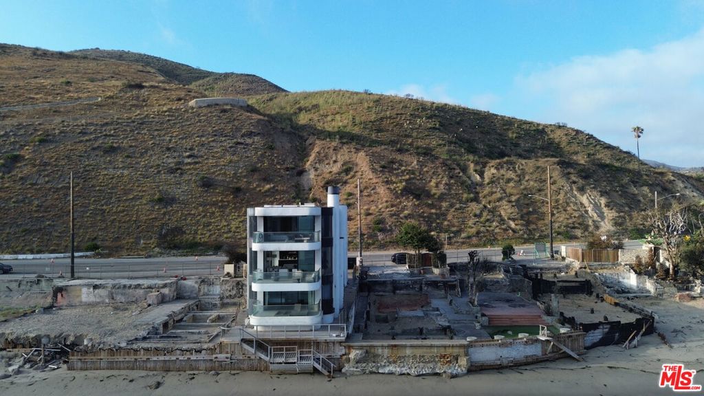 18860 Pacific Coast Highway The Miraculous Malibu SanctuaryNestled along the legendary coastline of Malibu, 18860 PCH is more than just a homeit's a symbol of resilience, grace, and divine preservation. While neighboring properties were tragically lost to devastating fires, this remarkable residence stood untouched, earning the nickname "The Blessed House." Locals and visitors alike speak of its survival as nothing short of a miracle.Featured in numerous magazines and online publications, this architectural gem blends sleek modern design with the raw beauty of nature. Expansive glass walls frame breathtaking panoramic ocean views, while clean lines, luxurious finishes, and open-concept living spaces create a seamless harmony between earth, sea, and sky.With direct access to the Pacific, serene outdoor terraces, and a peaceful energy that must be felt to be believed, 18860 PCH is not just a Malibu masterpieceit's a story of hope, beauty, and quiet strength.