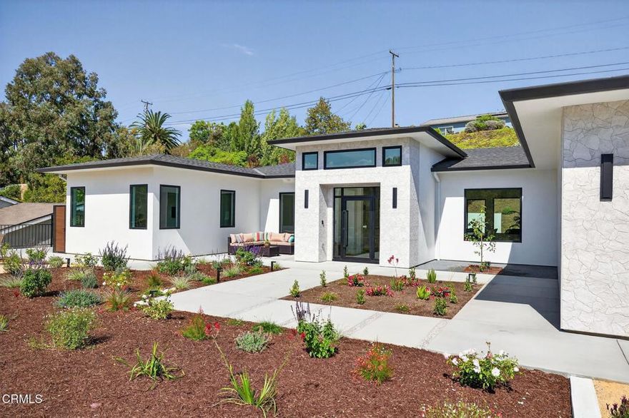 Welcome to Ondulando! A rare opportunity to own a brand-new construction home in one of Ventura's most sought-after neighborhoods. This modern single story residence is crafted with unparalleled attention to detail, thoughtful design, and high-end finishes. Inside you are greeted with an open concept floor plan perfect for entertaining and featuring elegant white oak engineered hardwood floors throughout. The chef's kitchen showcases top of the line appliances, a striking 9-foot center island, and a seamless flow into the spacious living room with 74' WiFi-enabled color changing LED fireplace adding to the inviting ambience of the home. This 4-bedroom, 4-bathroom masterpiece redefines luxury living with its split wing layout featuring two primary suites with incredible bathrooms with modern finishes, and each with private access to the covered patio. The extra spacious laundry room with ample cabinet space provides additional storage along with the two entry closets and hallway linen closet. Every detail was designed with efficiency and comfort in mind: individually zoned mini-split heating and cooling, a fully integrated solar system pre-wired for backup battery, EV charging readiness, and Halo 5 whole house water filtration system. Smart home upgrades include Ring doorbell, Sonos sound system with iPad control, and more! Spacious two car garage complete with epoxy finish. Step outside to your own private outdoor retreat featuring multiple sitting and dining areas, a fully equipped outdoor kitchen, fire pit, and tranquil fountain--the perfect setting for gathering year-round. From smart design to outdoor entertaining, this home delivers everything you've been waiting for! Come experience the perfect blend of luxury, innovation, and California living in this one-of-a-kind Ventura home.