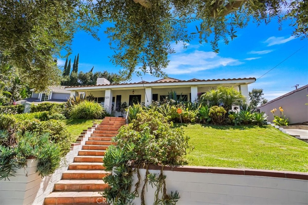 Classic California Ranch Home located on a cul-de-sac in the highly desirable Equestrian District “Burbank Rancho”. Perched on a knoll is this beautifully landscaped rare 4 bedroom, 2.5 bathroom home. Have coffee on your front porch and watch the equestrian riders go by on the equestrian trail just steps away. Upon entry you will feel the openness of this home. The living room has incredible vaulted beamed ceilings with a fireplace that warms the room. The dining area is open to a cook’s kitchen with a large center island and plenty of surface space. Down a central hallway are two first-floor bedrooms with a shared full bath and a powder room ½ bath for guests. Each bedroom is spacious with ample sized closets. There’s a large family room with double doors that lead to the patio. At the back of the home is a laundry room. Take the staircase up to large master retreat with vaulted ceilings, two closets, “one walk-in”. Double doors lead out to the balcony with views of the yard. The master bath is light and bright, including a soak tub and double sinks. The fourth bedroom has a large closet and views of the park. The private backyard has amazing gathering areas. It’s perfect to entertain friends and family. Additional features include: newer roof, HVAC, automatic gate, updated electrical panel, tankless water heater, dual pane windows, EV charger, lots of storage space, 2 car detached garage, Close proximity to studios, (Warner Bros, Disney, ABC and more), LA Equestrian Center, Whole Foods, Capitol Grille, Morton’s and more. Amazing Fact, this home is located in close proximity of 3 parks including the soon to be built Dick Clark Dog park.