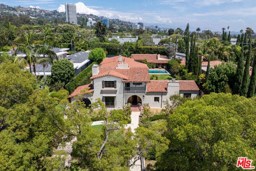 An Unparalleled Piece of Beverly Hills  History on North Maple Drive: For the first time in over 55 years, an extraordinary estate on one of Beverly Hills' most prestigious and coveted streets is available. 706 North Maple Drive is not just a home, but a living piece of Hollywood history. This stunning Spanish-style residence, once the private retreat for screen legends Elizabeth Taylor, Debbie Reynolds, Eddie Fisher, and a young Carrie Fisher, offers a once-in-a-lifetime opportunity to own a storied estate where timeless elegance meets Old Hollywood glamour. Nestled on an expansive 21,232 square foot lot on one of the most sought-after blocks in the Beverly Hills flats, this property sits elevated from the street, providing both privacy and prestige. North Maple Drive is renowned for its magnificent homes and quiet, tree-lined streets, offering the ultimate in luxury living. Built in 1929, this architectural Spanish gem spans nearly 6,500 square feet with 5 bedrooms and 4.5 baths in the main house. The classic two-story features elegant stained glass windows with intricate mosaics, setting the tone for the home's Spanish charm. The grand scale living room impresses with exposed wood beam ceilings and a stone fireplace, while high ceilings throughout the home create a feeling of spaciousness. The residence is designed for grand living and entertaining. A large formal dining room and a European-style kitchen with custom stonework are perfect for hosting. The breakfast room and a separate bar area open through French doors to the patios and gardens, showcasing an expansive yard, and a stunning mosaic tile pool with an exterior dedicated three quarters bathroom. The backyard features a large patio and lawn, ideal for gatherings. The property also includes a 2 bed room guest house with a Jack and Jill bathroom, a separate half bath, wood beam ceilings, a three-car garage, and a long driveway for additional on-site parking for comfort and convenience. This is more than just a home; it's a rare chance to own a piece of entertainment royalty on one of Beverly Hills' most sought after streets. Don't miss this opportunity to blend Hollywood's past with your future!