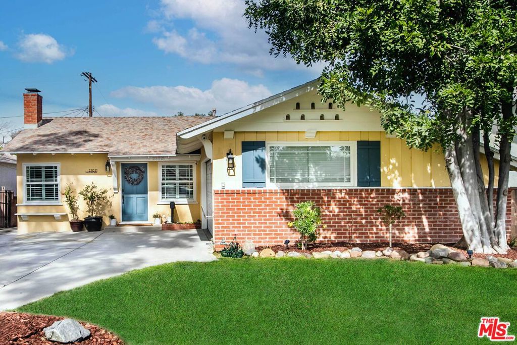 Sellers are open to a possible interest rate buy-down or credit toward the buyer's closing costs, depending on the final purchase price and terms. Welcome to this lovely single-story home, perfectly situated on one of the area's most picturesque, tree-lined streets. Located just south of Ventura Blvd and west of Topanga Canyon, this residence is a stone's throw from the highly acclaimed Woodland Hills Elementary Charter for Enriched Studies. Step inside to a warm and inviting living room, highlighted by a brick fireplace, rich hardwood floors, plantation shutters, and abundant natural light. The spacious kitchen features sleek granite slab countertops, stainless steel appliances, beautiful Hickory cabinetry, and ample storage space. An expansive family room with a second fireplace offers versatile space ideal for entertaining, creating the ultimate media room or playroom. French doors open out to a spacious patio surrounded by bountiful orange and avocado trees, along with a covered patio perfect for year-round gatherings and al fresco dining. Additional highlights include upgraded bathrooms, a dedicated laundry room, a tankless water heater, a Nest thermostat, and a newer HVAC system. The garage features a workbench and a darkroomperfect for hobbyists, creatives, or extra storage needs. The home offers four bedrooms, two updated bathrooms, and a half bathroom in the primary bedroom. Enjoy quick access to the new Los Angeles Rams practice facility, Topanga Village, Warner Center, the Commons at Calabasas, Bristol Farms, Starbucks, hiking trails, parks, and beloved local favorites like Blinkie's Donuts, Tomato Pie Pizza, Casalena, Monty's Steakhouse and Joey's. With convenient freeway access and just 13 scenic miles through Topanga Canyon to the beach, this home offers the perfect balance of suburban charm and coastal convenience.