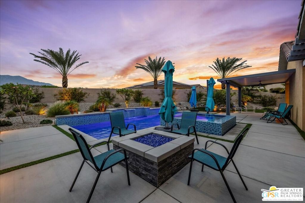 A Rare Jewel in Del Webb Rancho Mirage Prepare to be wowed - this extraordinary residence is unlike any other in the community. Perfectly situated on a premier Phase 6 street, this highly sought-after Haven floorplan sits on an expansive lot with a private resort-style backyard showcasing breathtaking San Jacinto Mountain views. Complete with owned solar, this home is as efficient as it is stunning. From the moment you step inside, you'll notice the elevated design and attention to detail. Upgrades abound, including wood-look plank tile flooring, designer window treatments, custom LED lighting, and high-end ceiling fans throughout. The open-concept layout highlights a chef's kitchen with 42" upgraded cabinetry, modern brushed nickel hardware and fixtures, and a large island offering seating and spectacular views of the pool and mountains. The living and dining spaces exude sophistication with built-in display niches, a hand-selected chandelier, and an upgraded center-opening glass slider that seamlessly connects to the outdoors. Beyond, an extended covered patio with bubbler fountain and beautifully landscaped side yard set the stage for alfresco living. The primary suite is a private sanctuary with direct outdoor access through an optional glass door and an expanded ensuite bath featuring dual vanities, abundant storage, a luxurious rain shower, and a large walk-in closet. The guest suite, positioned at the opposite end of the home, offers comfort and privacy with access to the secondary upgraded full bath appointed with quartz counters and modern finishes. Designed for both relaxation and entertaining, the backyard is a true showstopper. A custom elevated infinity spa spills into the sparkling pool, complemented by a fire pit and sweeping mountain views that transform every evening into a retreat. An additional courtyard off the kitchen enhances the flow of indoor-outdoor living, making this floorplan perfectly suited for this remarkable lot. Additional features include a climate-controlled oversized garage, built-in shoe station, upgraded tech package with Cat6 hardwired outlets inside and out, Wi-Fi extender, and smart garage door opener and front door lock systems. As part of Del Webb Rancho Mirage, residents 55+ enjoy resort-style amenities including a clubhouse with bar and billiards, fitness center, sparkling community pools and spa, tennis, pickleball, bocce ball, and an active social calendar. This is more than a home - it's a rare lifestyle opportunity on one of the most exceptional lots in Del Webb.