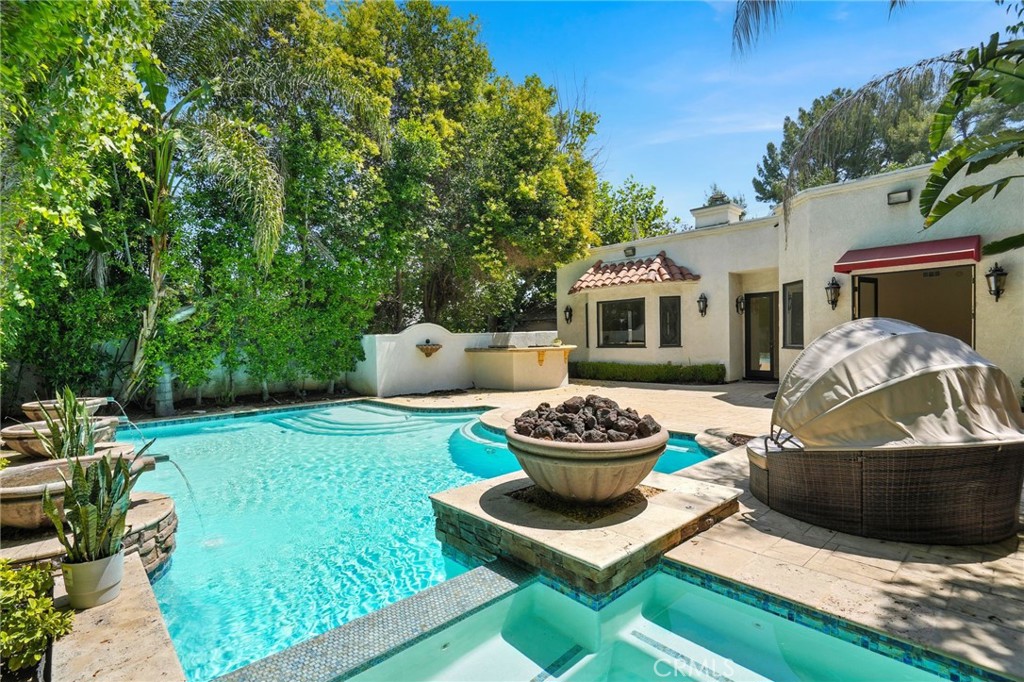 Live the resort life every day in this gated, single-story Mediterranean showplace tucked just south of Tarzana Boulevard. Designed for both relaxation and entertainment, this home features an open-concept layout flooded with natural light, soaring ceilings, and spacious living and dining areas perfect for everything from cozy nights in to lively gatherings. The chef’s kitchen has been thoughtfully upgraded with modern cabinets, stylish sinks, and sleek finishes, while each of the four bedrooms boasts its own fully remodeled en-suite bath. The primary suite takes it up a notch with a private sauna.
Step outside into your private backyard oasis—complete with a sparkling pool and spa, outdoor bar/BBQ area, and a basketball court for active fun. Whether you're enjoying morning coffee or hosting under the stars, it’s the ultimate entertainer’s dream.
The garage has been transformed into a versatile bonus space, ideal for movie nights with its projector setup, or as a private office with its own side entrance. The home is available furnished if needed, and we’re open to short-term rental options and can work with most insurance companies.
Located on a flat, sidewalk-lined street with excellent neighbors who truly care about the community, you'll enjoy peace and quiet while being just a short walk to LA Fitness, Trader Joe’s, Sephora, Nordstrom Rack, and most local synagogues. It’s a rare blend of luxury, convenience, and warmth in one turn-key package.