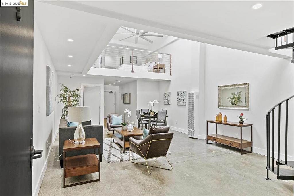 Sleek 1 B/1.5b West Oakland loft. Measures in at 960 Sq Ft of sun-drenched living space across 2 levels (Pub Recs show 810 Sq Ft). Main level houses living room, dining room, modern kitchen w/ quartz counters and SS appliances, W/D closet, and 1/2 bath. Open floor plan, sealed concrete floors, & towering ceilings w/ huge skylights. Second level accessed by spiral staircase. Wraps around the living space and contains the bedroom, full bathroom, and spaces for bedroom lounge and cozy study. Bedroom suite features walk-in closet, wall-to-wall carpet, niche for bureau or writing desk, and enviable ensuite bathroom w/ skylight and luxurious tiled walk-in shower. Only 9 units in the Center Street Lofts, a luxury live/work condominium in converted 1920’s Oakland warehouse located in heart of West Oakland’s creative community. West Oakland BART just 5 blocks away. Convenient access to Highways 80, 880, 980.