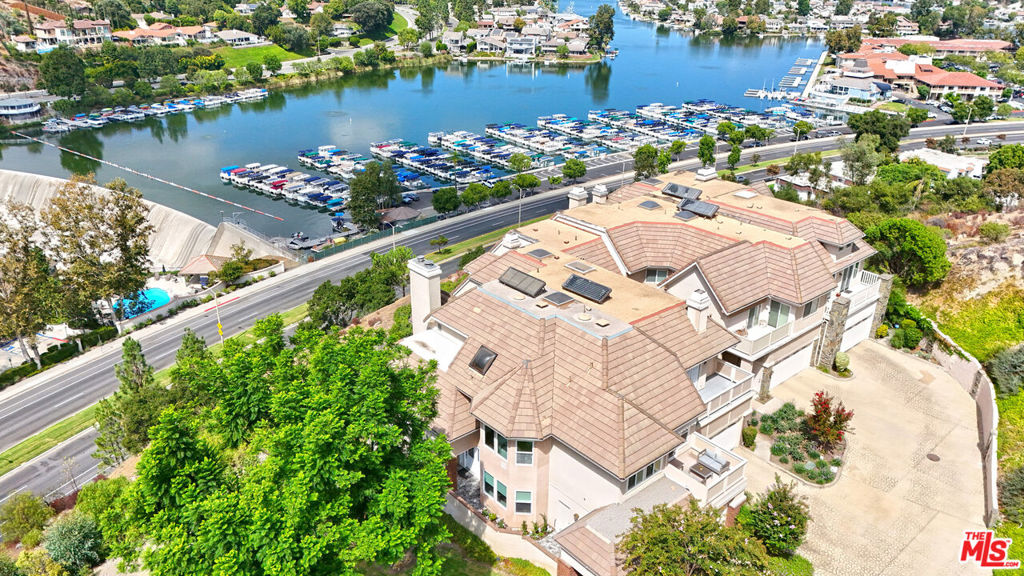 Stunning Westlake Pointe end town home with unobstructed panoramic views of the lake and Santa Monica Mountains from virtually every room. Perched above the lake and located next to open lawns, with just one shared wall, this west facing 4 bedroom, 3 bath spacious home enjoys ultimate privacy. Completely renovated from top to bottom, the property has been transformed into a modern, entertainer's showplace with clean, spare lines, utilizing the highest quality styling and finishes. Flooded with natural light, the open flowing living spaces feature a spectacular beamed cathedral ceiling living room, stylish eat-in chef's kitchen with stainless steel appliances, new gleaming bathrooms with top of the line fixtures, new hardwood and porcelain floors and custom lighting. The huge primary suite and spa-like bathroom with a lovely view patio offer a gentle refuge from the bustle of the day. Enjoy the glorious sunsets from your spacious patio with motorized retractable awnings. Steps to the pool, the lake and close to award-winning schools, this private and serene showplace is the perfect retreat, yet is just minutes from the heart of Westlake Village.
