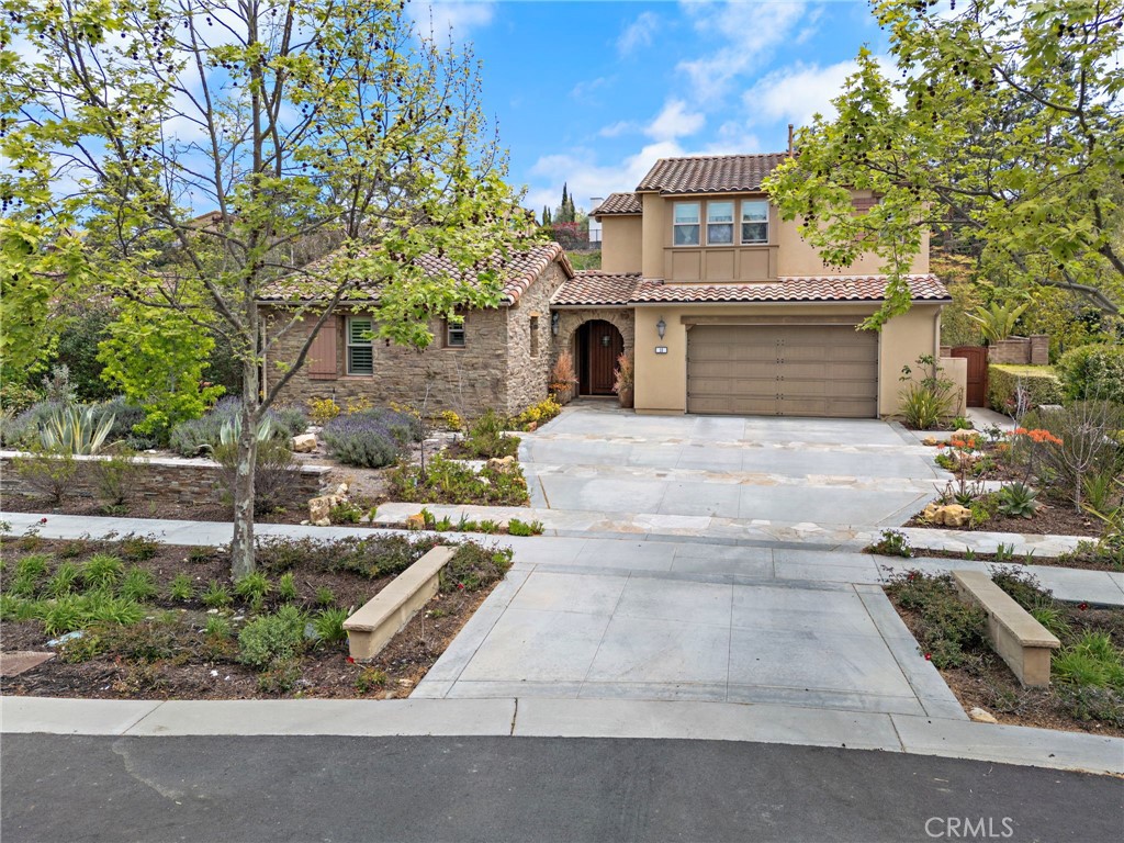 Located on an idyllic cul-de-sac with a central landscaped island in the newer Legacy Collection at Ladera
Ranch’s guard-gated Covenant Hills, this impressive home rivals the luxury and craftsmanship of custom
estates. Move-in ready, the expansive design is host to five ensuite bedrooms and five- and one-half baths
in approximately 4,225 square feet of refined living space, ensuring ample comfort and privacy for you and
your guests. Three bedrooms are located on the first floor, including a grand primary suite that opens to the
home’s large courtyard and features a walk-in closet, soaking tub, separate shower and two vanities. Two
additional suites join a spacious loft on the second level. An upscale aesthetic is infused throughout the
home, emphasized by a formal entrance, a stunning foyer with dramatic staircase and glass doors leading to
the courtyard, and a dining room for picture-perfect entertaining. Opening to the courtyard and the backyard,
the light and open family room showcases a vaulted ceiling with open beams, an elegant fireplace and
plenty of room for large gatherings. In the kitchen, top-of-the-line stainless steel appliances include a built-in
refrigerator, double oven and a six-burner range with griddle and matching hood. Wood cabinetry, stone
countertops, an oversized island, walk-in pantry, and full-tile backsplash are also featured. Archways,
handsome millwork and stylish lighting fixtures complement plantation shutters, hardwood flooring, and
granite and marble finishes throughout the residence, while a spacious laundry room and an attached three-
car garage embellish convenience. With a scenic landscaped hill as a backdrop, grounds enjoy privacy while
offering the beauty of mature landscaping, colorful plantings, and a large lawn the extends off the courtyard. At home garden enthusiast...this is perfect yard for you.
Stone tile enriches patios that welcome outdoor relaxation and socializing with friends and neighbors. Built
by Warmington Residential, The Legacy Collection is close to the exclusive Covenant Hills clubhouse,
complete with swimming, tennis and much more. Community parks and miles of trails are nearby, and
Ladera Ranch’s vibrant shopping centers, outstanding schools and phenomenal recreational attractions are
minutes from home.