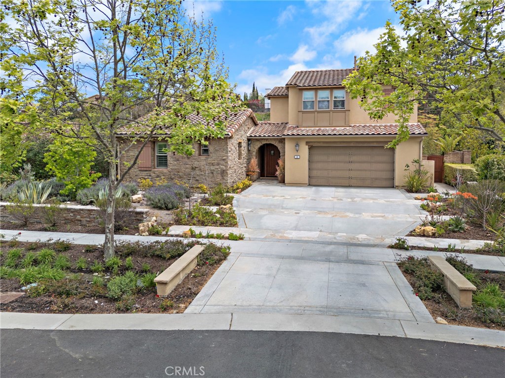 Located on an idyllic cul-de-sac with a central landscaped island in the newer Legacy Collection at Ladera
Ranch’s guard-gated Covenant Hills, this impressive home rivals the luxury and craftsmanship of custom
estates. Move-in ready, the expansive design is host to five ensuite bedrooms and five- and one-half baths
in approximately 4,225 square feet of refined living space, ensuring ample comfort and privacy for you and
your guests. Three bedrooms are located on the first floor, including a grand primary suite that opens to the
home’s large courtyard and features a walk-in closet, soaking tub, separate shower and two vanities. Two
additional suites join a spacious loft on the second level. An upscale aesthetic is infused throughout the
home, emphasized by a formal entrance, a stunning foyer with dramatic staircase and glass doors leading to
the courtyard, and a dining room for picture-perfect entertaining. Opening to the courtyard and the backyard,
the light and open family room showcases a vaulted ceiling with open beams, an elegant fireplace and
plenty of room for large gatherings. In the kitchen, top-of-the-line stainless steel appliances include a built-in
refrigerator, double oven and a six-burner range with griddle and matching hood. Wood cabinetry, stone
countertops, an oversized island, walk-in pantry, and full-tile backsplash are also featured. Archways,
handsome millwork and stylish lighting fixtures complement plantation shutters, hardwood flooring, and
granite and marble finishes throughout the residence, while a spacious laundry room and an attached three-
car garage embellish convenience. With a scenic landscaped hill as a backdrop, grounds enjoy privacy while
offering the beauty of mature landscaping, colorful plantings, and a large lawn the extends off the courtyard. At home garden enthusiast...this is perfect yard for you.
Stone tile enriches patios that welcome outdoor relaxation and socializing with friends and neighbors. Built
by Warmington Residential, The Legacy Collection is close to the exclusive Covenant Hills clubhouse,
complete with swimming, tennis and much more. Community parks and miles of trails are nearby, and
Ladera Ranch’s vibrant shopping centers, outstanding schools and phenomenal recreational attractions are
minutes from home.