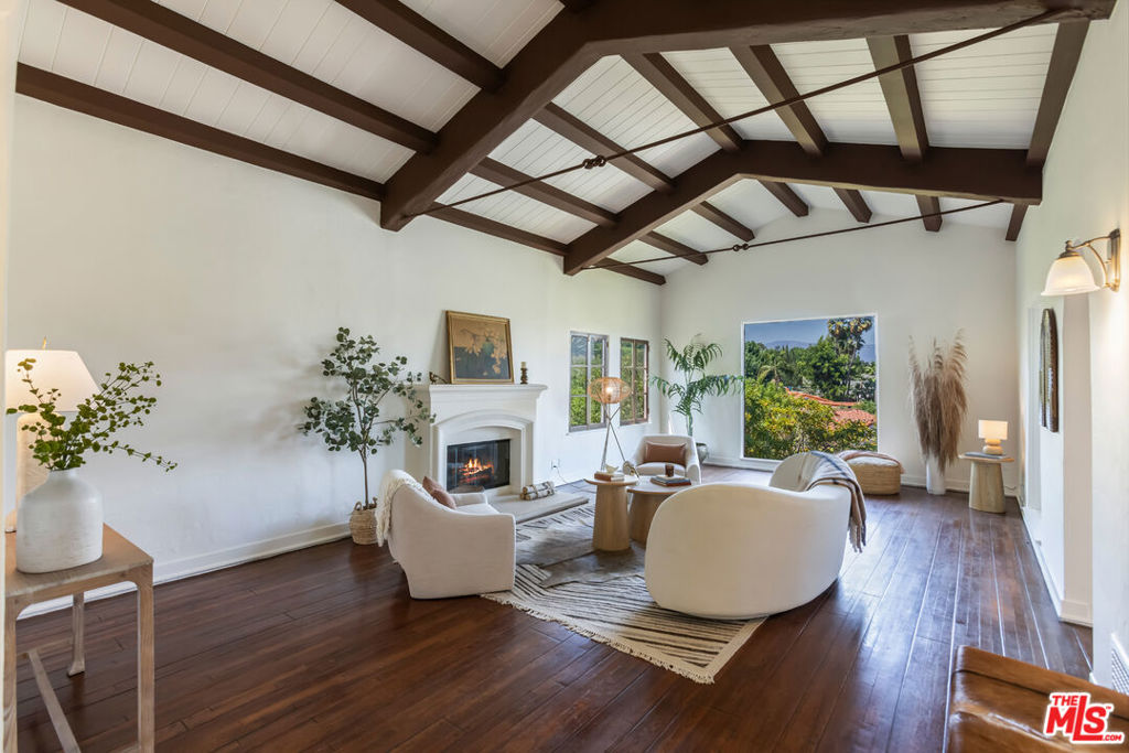 This stunning Spanish home located in Silver Lake's highly coveted Moreno Highlands. A welcoming arched front gate, a beautiful arched front door framed by tiered stucco detailing, and a front courtyard accented with colorful tile. Inside, the home features timeless character, with a foyer highlighted by elegant leaded glass windows and a formal living room that offers wood beamed ceilings, a fireplace, and oversized windows with lush treetop and hillside views. A formal dining room with arched doorways adds charm, while the breakfast area with wood beamed ceilings captures serene treetop and lake views. The kitchen provides abundant cabinetry and generous counterspace, making it ideal for cooking. The first floor also includes a versatile office or bedroom with a guest bathroom. Downstairs are three bedrooms and two bathrooms. The primary bedroom with an arched window includes an ensuite bathroom and a walk-in closet for comfort and privacy. An additional oversized bedroom features a fireplace and its own walk-in closet, with both rooms offering direct access to the backyard. The expansive backyard provides plenty of space to relax, entertain, and enjoy the outdoors. Ideally located in the highly desirable district for Ivanhoe Elementary School, near the Silver Lake Reservoir, LaMill Coffee, L&E Oyster Bar, Bar Siesta, Trader Joe's, and Gelson's. Don't miss this incredible opportunity to own a beautiful home!
