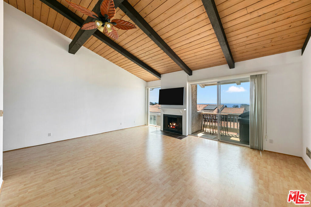 Positioned on the top row of the highly sought-after Malibu Villas, this end-unit townhome captures breathtaking ocean views from a peaceful, elevated vantage point. Located within a guard-gated community just across the street from Malibu's iconic beaches, this 2-bedroom plus a loft residence offers the perfect blend of comfort and coastal charm. Step inside to find an open, airy layout featuring vaulted ceilings, expansive windows, and hardwood floors. The living room is centered by a wood-burning fireplace, ideal for cozy Malibu evenings and relaxing entertainment. The gourmet kitchen features granite countertops, maple cabinetry, and stainless-steel appliances, including two ovens, a stovetop, dishwasher, and refrigerator. The primary suite offers a private retreat with an en-suite bathroom, walk-in closet, and private balcony. There is a second en-suite bedroom with access to an outdoor courtyard, plus a versatile loft area which can be used as a third bedroom, home office, or creative studio. The home is complete with an in-unit washer and dryer and a private two-car garage. Residents of Malibu Villas enjoy exclusive access to resort-style amenities, including a communal pool, spa, and clubhouse, all set among lush landscaping and just a moment's trip from sandy beaches, beautiful hiking trails, and local Malibu shops.