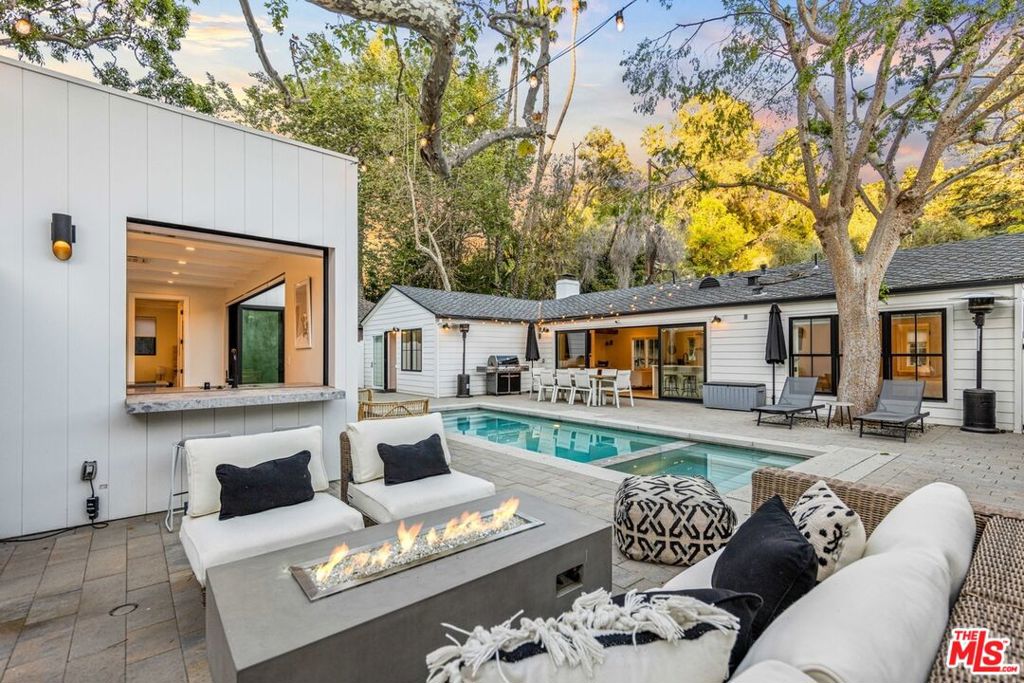 **FURNISHED Mid to Long-Term Rental** Modern luxury living in the Hollywood Hills. Completed in 2021 and originally built for the owner, this designer residence showcases top-tier craftsmanship, furnishings, and smart-home technology. The main house features 2 bedrooms (King/Queen) with en-suite baths finished in handmade Moroccan zellige tile, walk-in closets, and a guest powder room. The open-concept layout offers abundant natural light, motorized window coverings, a gas fireplace, and a chef's kitchen with Thermador appliances, Carrara marble countertops, and a 70-bottle dual-zone wine fridge. The converted garage serves as a bonus room with HVAC, laundry, gym area, office, and queen sleeper sofa. The pool house (ADU) includes a full Bosch kitchen, living area, bedroom with en-suite bath, and pool-access shower. Outdoor entertaining features over 2,000 SF of patio space with dining for 10, a fire-pit lounge, outdoor bar, heated saltwater pool with oversized spa, automatic cover, and custom lighting. Additional highlights include gated driveway parking, ample street parking, and proximity to Franklin Village and Bronson Canyon trailhead. Tenant pays LADWP, SoCalGas, WiFi, and bi-weekly cleaning. Owner covers gardener and pool service. No smoking. Pricing varies based on lease term, inquire for desired term and dates as well as rentals for events, productions, or a discount for renting the main house only (no ADU).